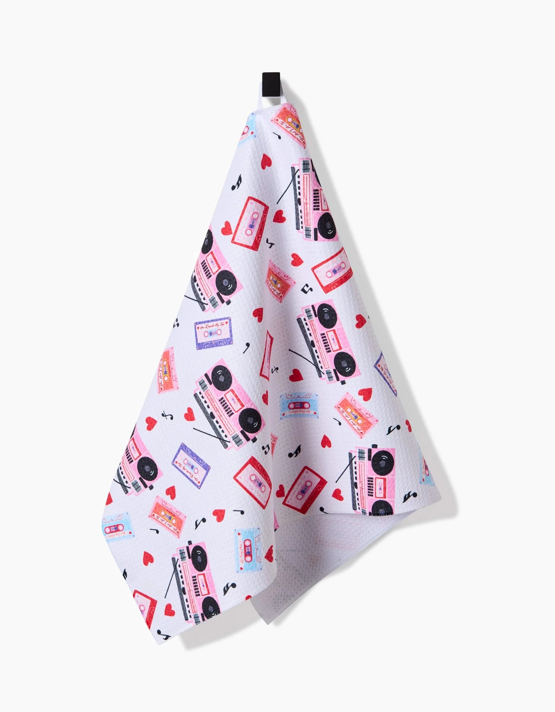 The Love Playlist kitchen towel by Vaishali Design Studio is white, made from recycled material, includes a hanging loop, and showcases a colorful cassette tape, boombox, music note, and red heart pattern.