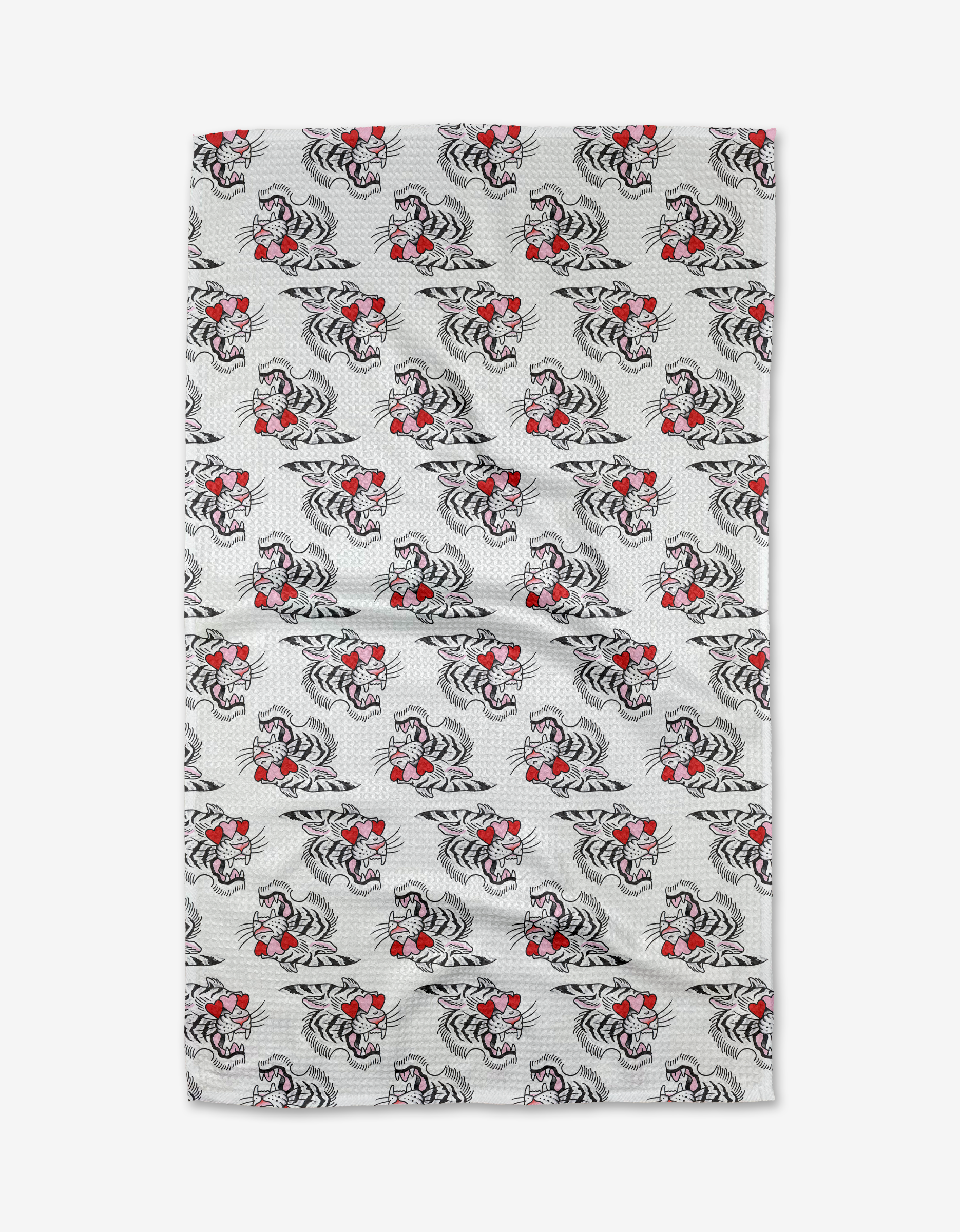 A rectangular tea towel by Cole Strem named Love Tiger, featuring repeating black and white tiger patterns with red bowties on a white dotted background, crafted from recycled materials.
