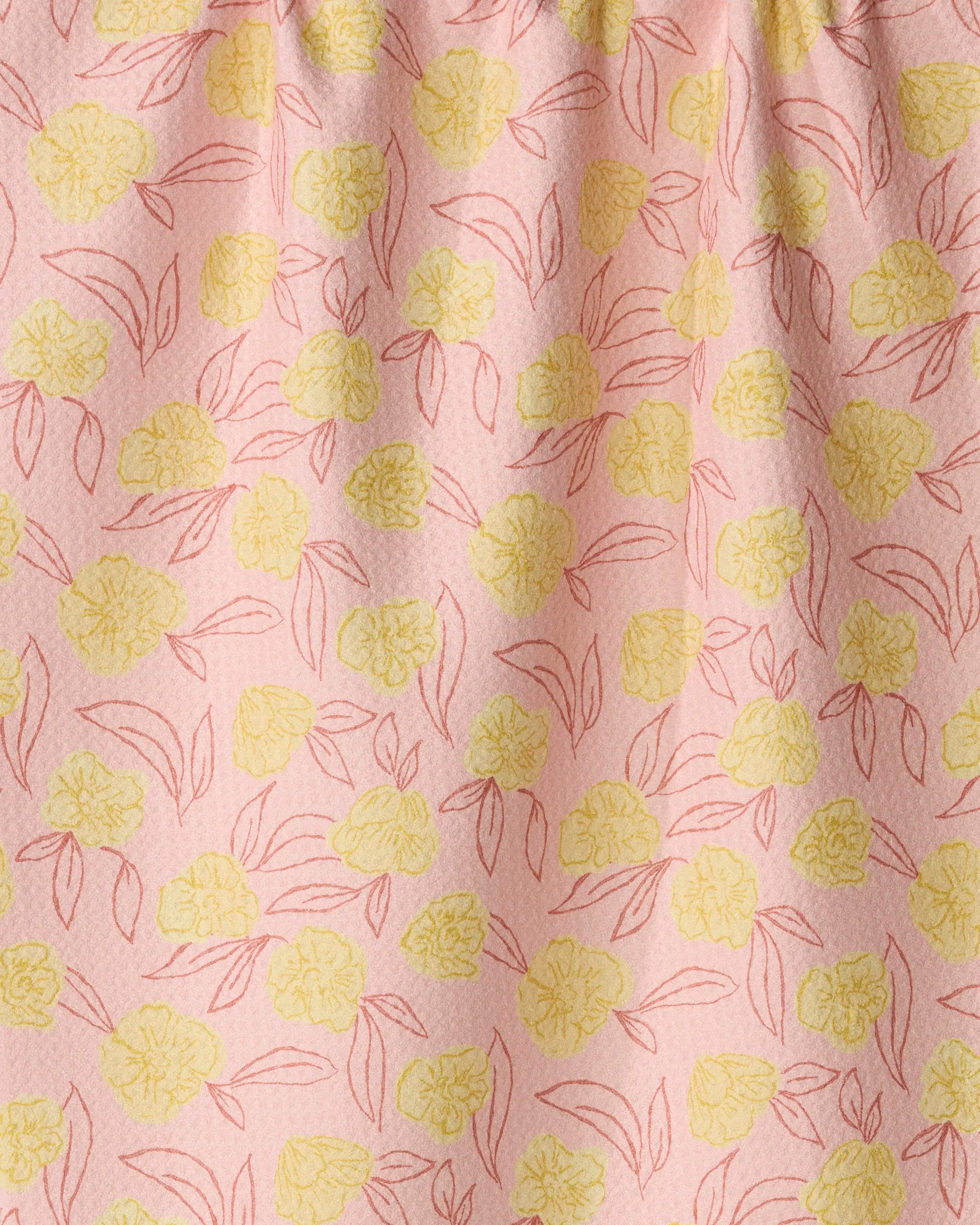Introducing the Lucky Bloom kitchen tea towel by Geometry—a beautifully designed piece crafted from recycled materials for an eco-friendly addition to your home. This pink tea towel features a textured surface, decorated with an even scatter of yellow flowers and red-outlined leaves and petals. The top is elegantly gathered, blending functionality with vibrant style for your kitchen.