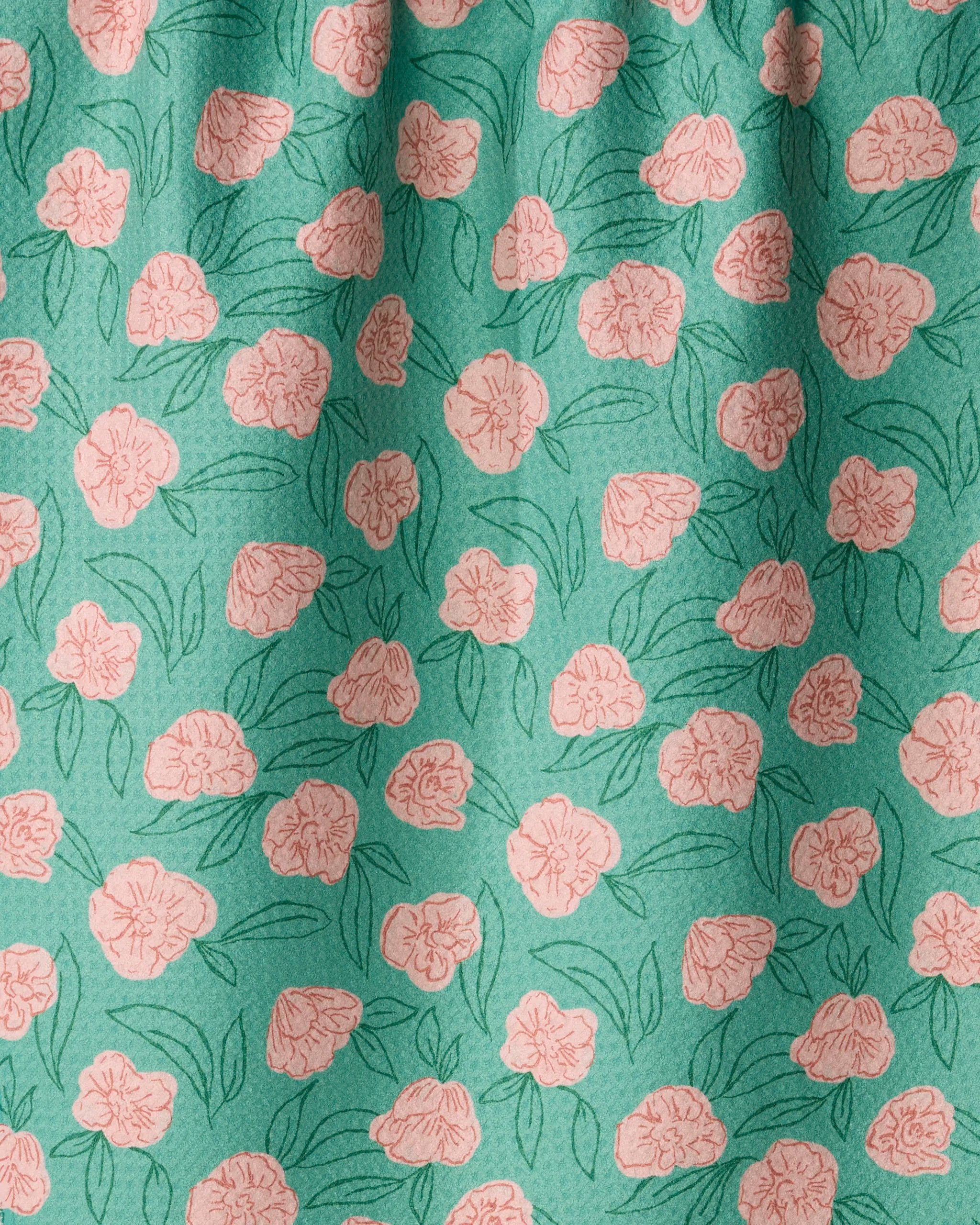 Geometry’s Lucky Bloom towel features green fabric adorned with a lively pattern of pink flowers and green leaves. Gentle folds create subtle shadows and texture across the absorbent, quick-drying surface, making this eco-friendly towel both practical and stylish. Crafted from recycled materials, it’s a sustainable addition to any kitchen.