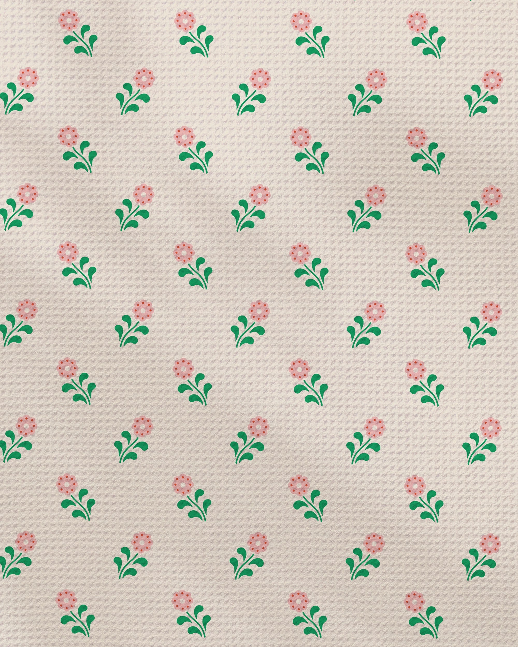 Brighten your kitchen with Geometry's Lucky Blossom dish towel, featuring a quick-drying fabric adorned with a repeating pattern of small pink flowers and green leaves on a textured beige background.