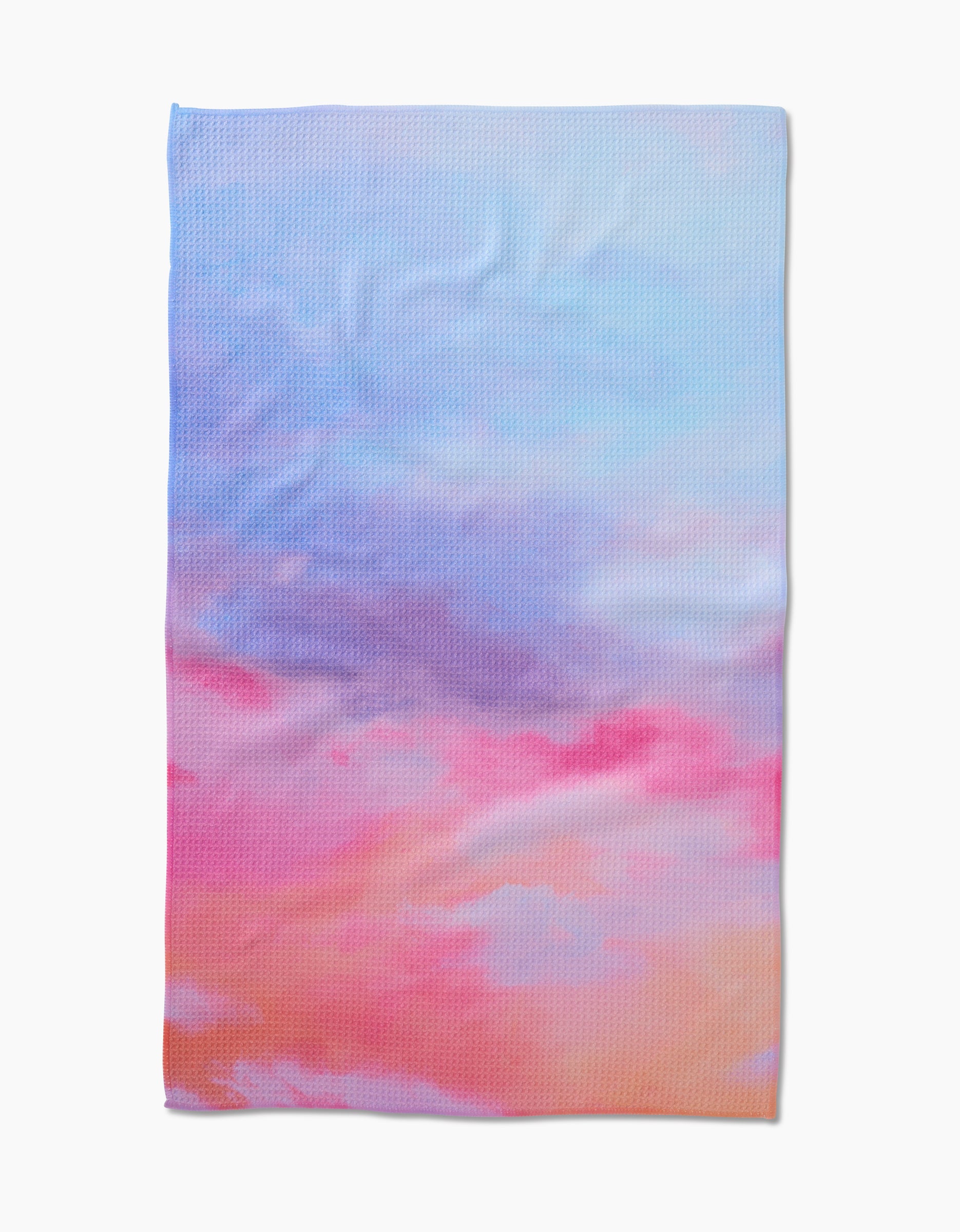 The Stefanie Bales Magic In The Sky tea towel is crafted from Geoweave fabric and showcases a dreamy pastel gradient of blue, pink, purple, and peach—evoking the colors of a sunset sky.