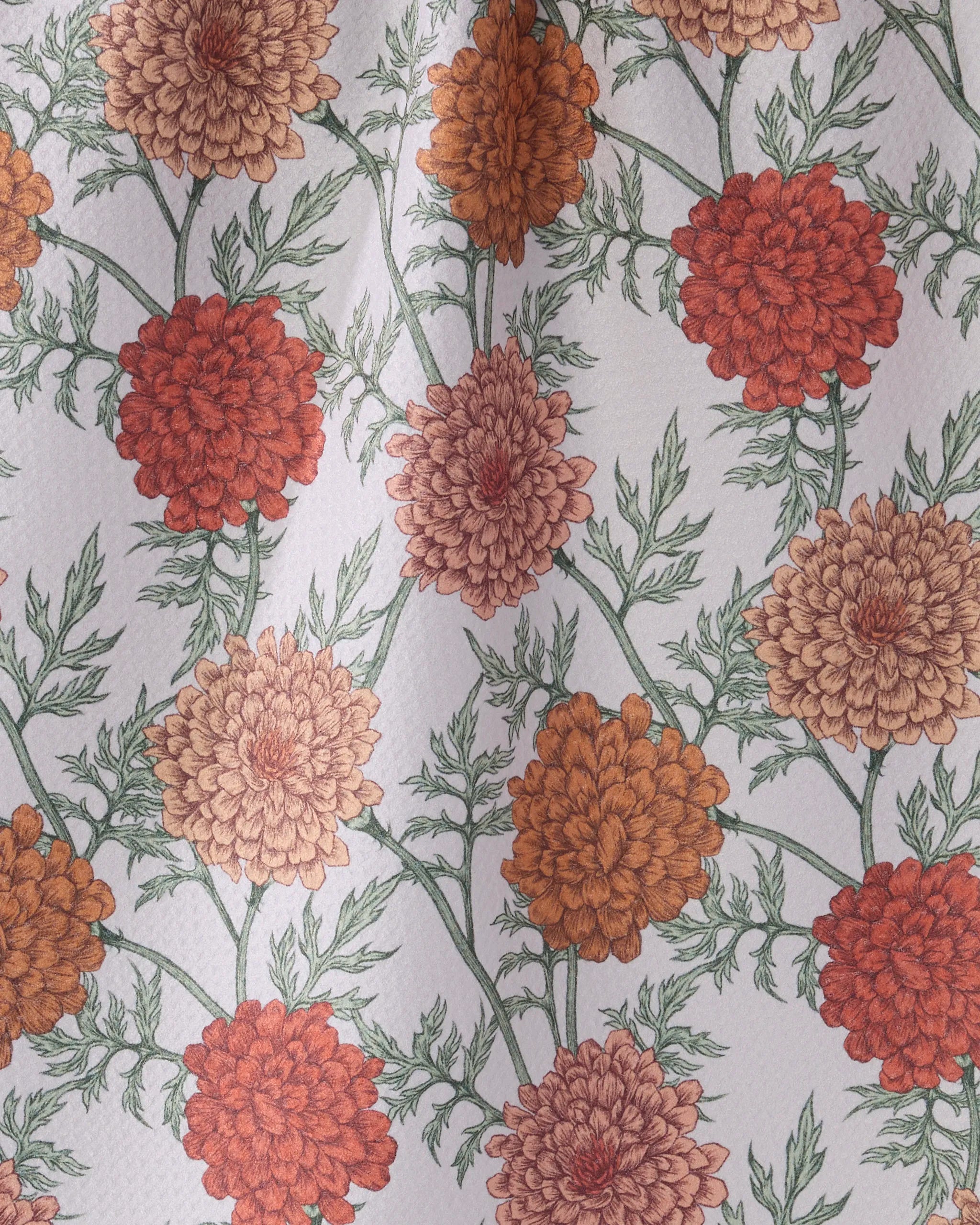 Marigold Manor by Geometry features a vintage, hand-drawn floral pattern with large red, orange, and peach chrysanthemums and green leaves on a light background—perfect for an ultra-absorbent or decorative kitchen tea towel.