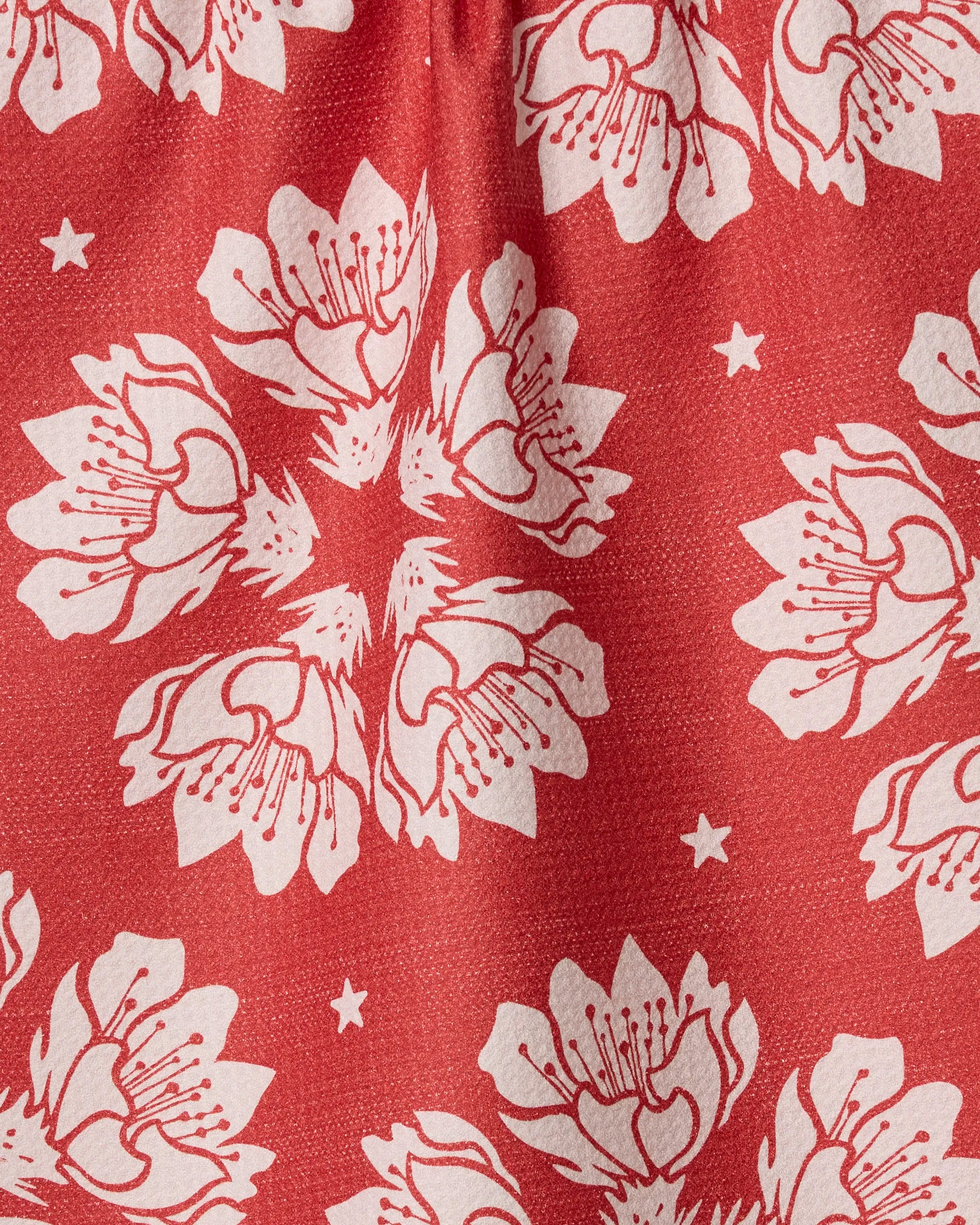 Geometry’s Maverick Floral features a hand-drawn red design with white flowers and stars, ideal for eco-friendly kitchen towels made from recycled materials.