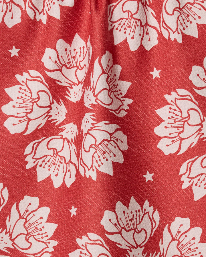 Geometry’s Maverick Floral features a hand-drawn red design with white flowers and stars, ideal for eco-friendly kitchen towels made from recycled materials.