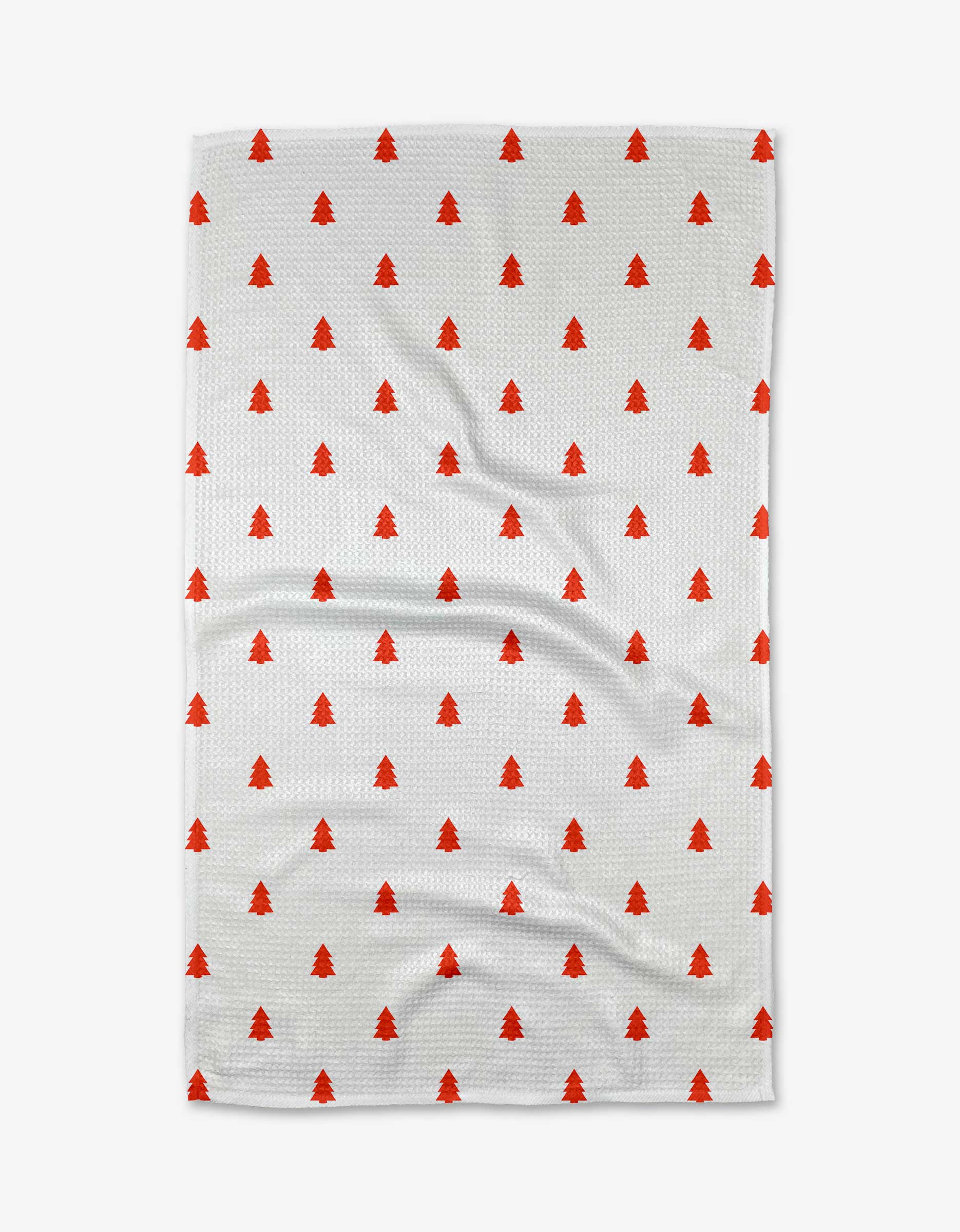 The Kailee Wright Merry tea towel is white with a repeating pattern of small red Christmas trees and is crafted from recycled materials.
