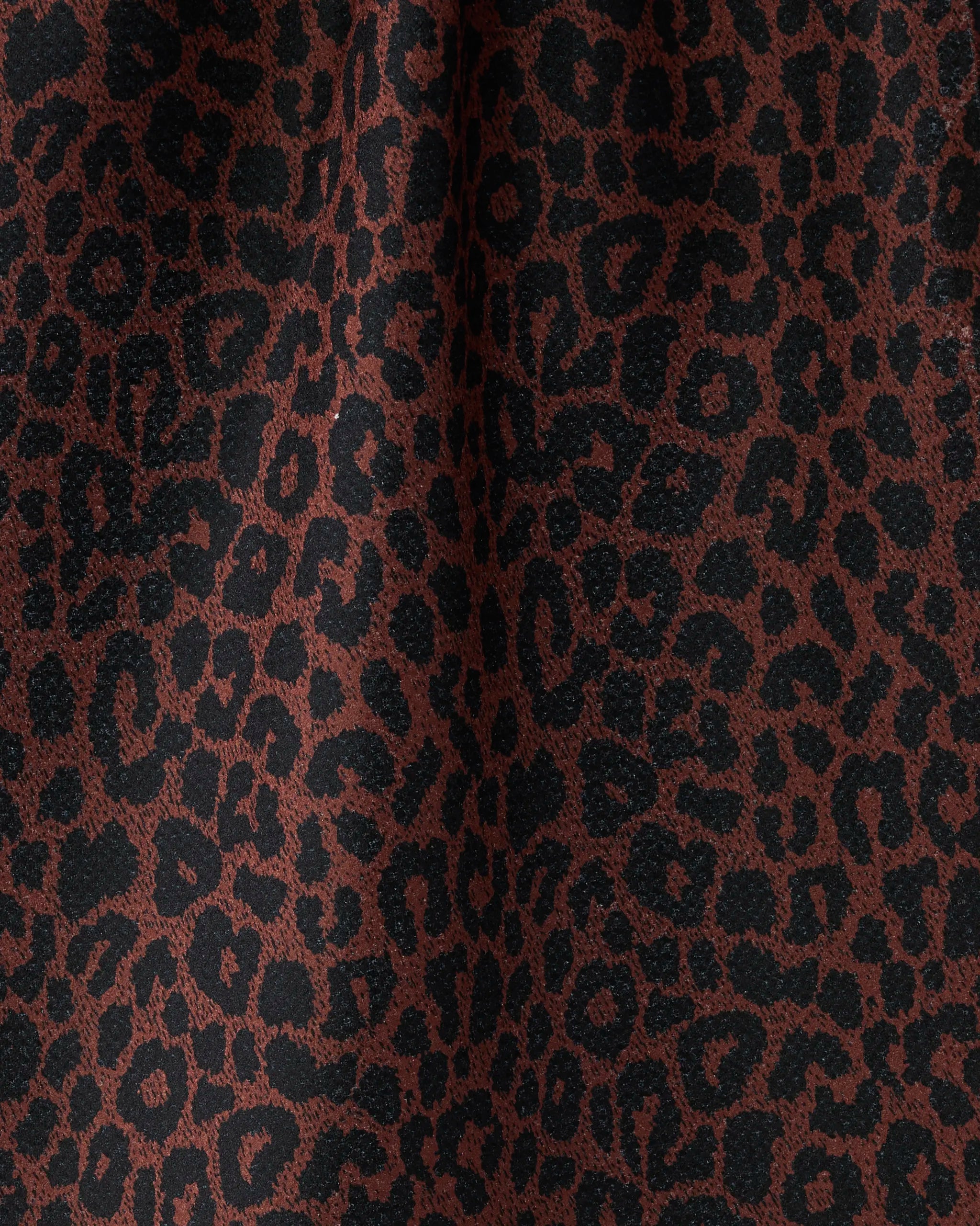 Close-up of the Geometry Midnight Safari dish towel, featuring an absorbent fabric with a soft texture and leopard print pattern in brown and black.