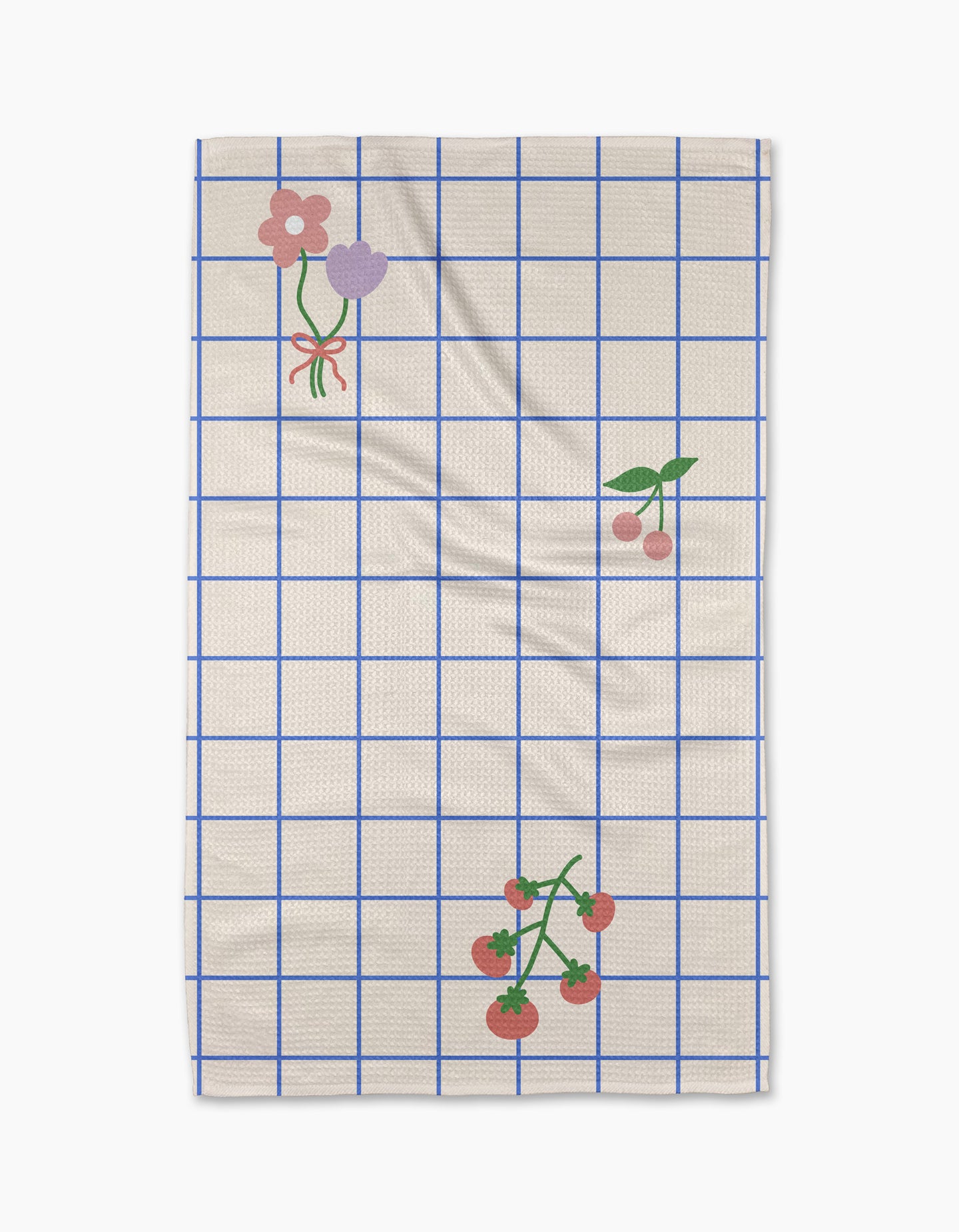 The Mini Harvest tea towel by Letters By Shells features a cream base with a blue grid, decorated with pink and purple flowers, cherries, and tomatoes—crafted from recycled materials for an eco-friendly touch.