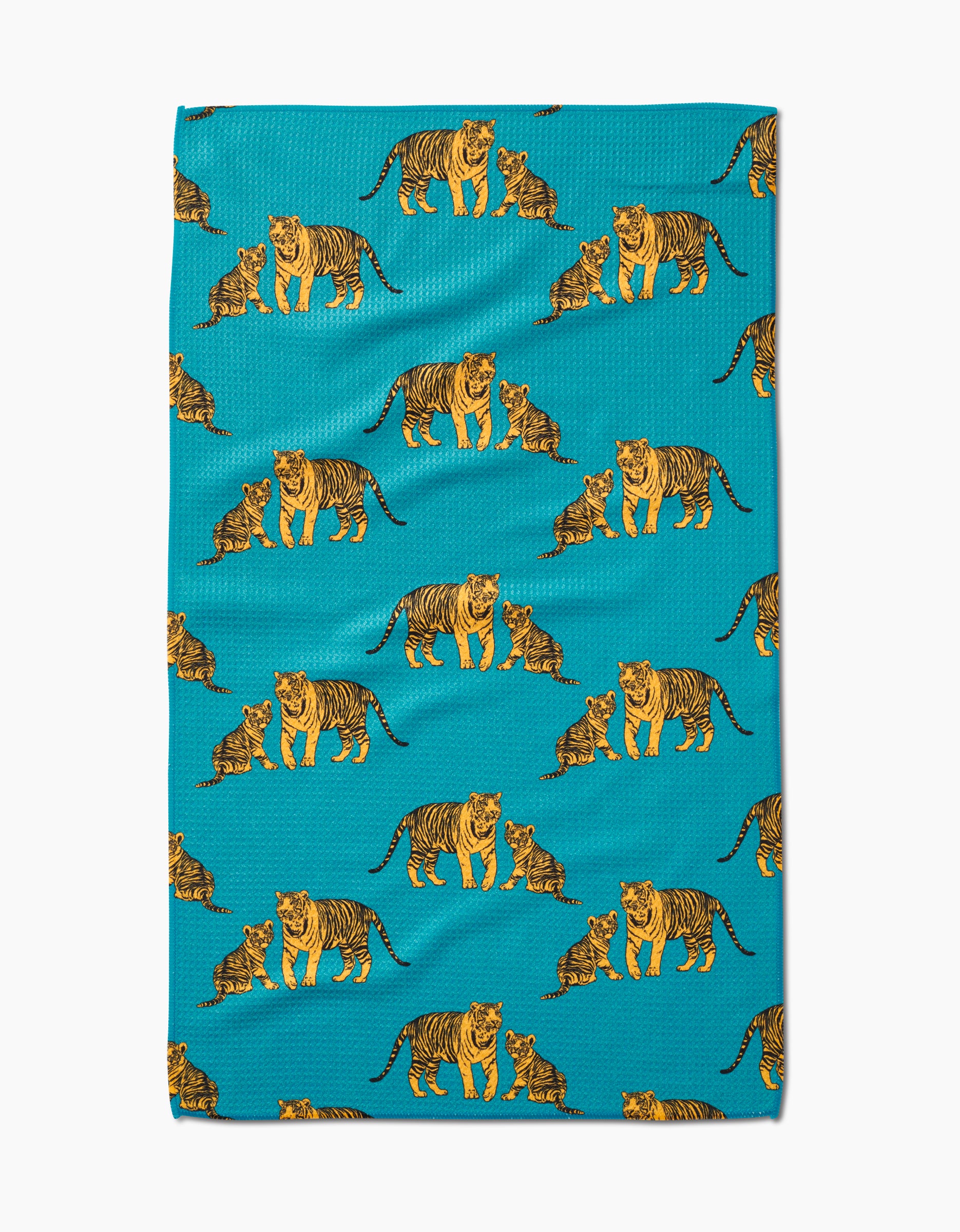 The Mommy and Me tea towel by Sarah Holden features a turquoise Geoweave fabric with a repeating pattern of orange, black, and white adult tigers and playful cubs.