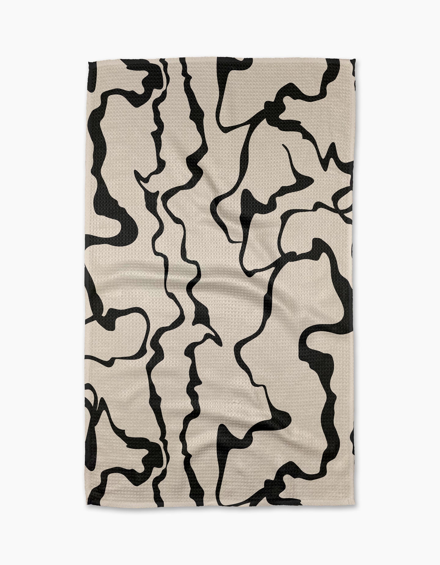 The Monochrome Liquid tea towel by Marina Solodka is beige, rectangular, made from recycled materials, and features an abstract black squiggly line pattern—shown laid flat on a white background.