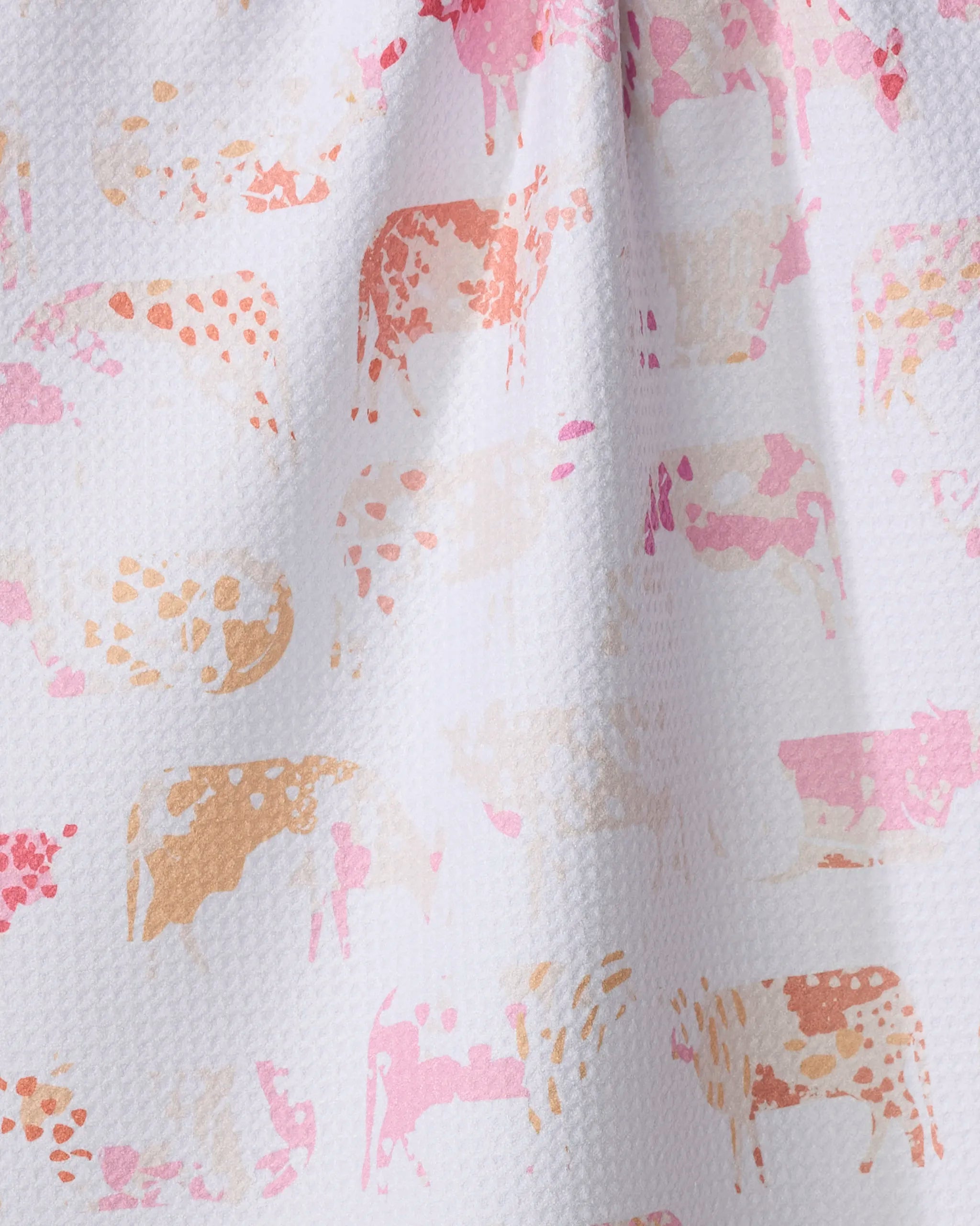 The "Moods" tea towel by Elisabeth Wing features a white textured design with abstract cow silhouettes in pink, peach, and light brown watercolor style—ultra-absorbent and perfect for adding playful charm to your kitchen.