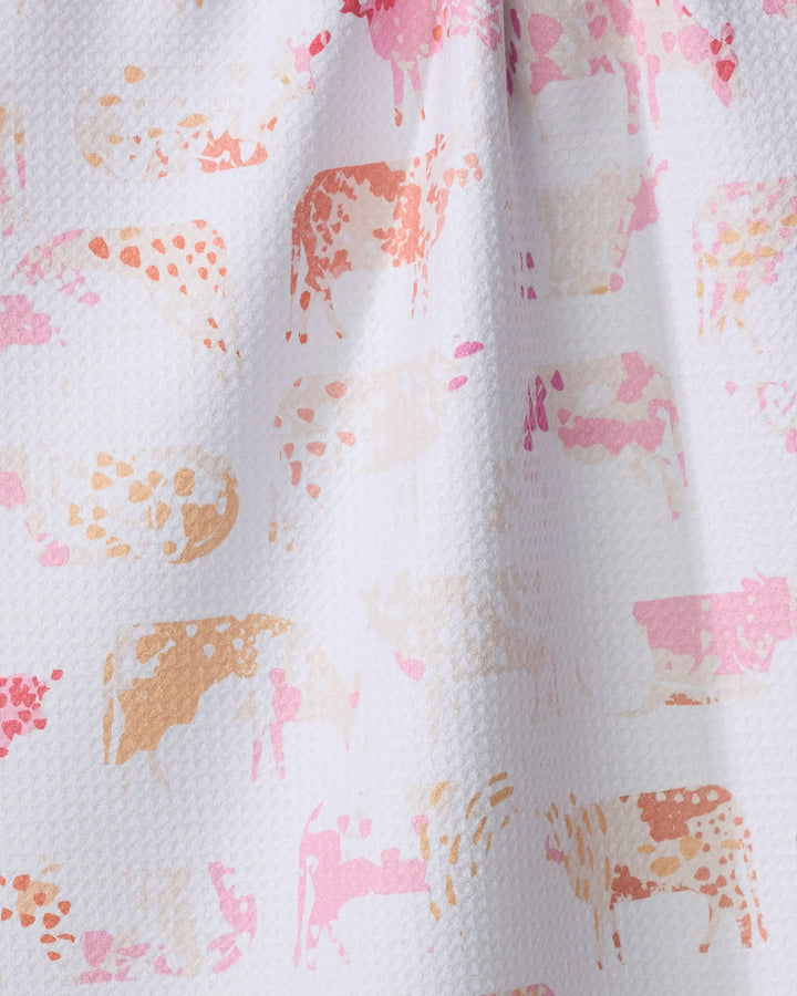 The "Moods" tea towel by Elisabeth Wing features a white textured design with abstract cow silhouettes in pink, peach, and light brown watercolor style—ultra-absorbent and perfect for adding playful charm to your kitchen.