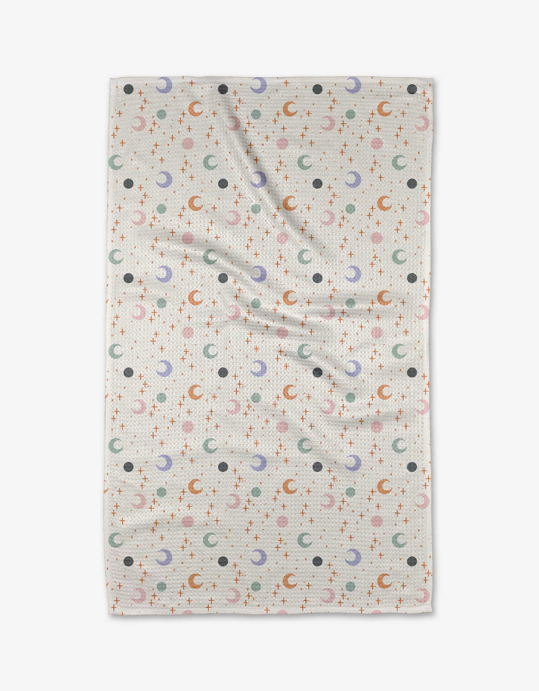 The Moons and Stars blanket by Charlie Rowan Designs is ultra-absorbent, made from recycled materials, and features a white background with orange stars, blue and orange moons, and black dots in a repeating pattern.