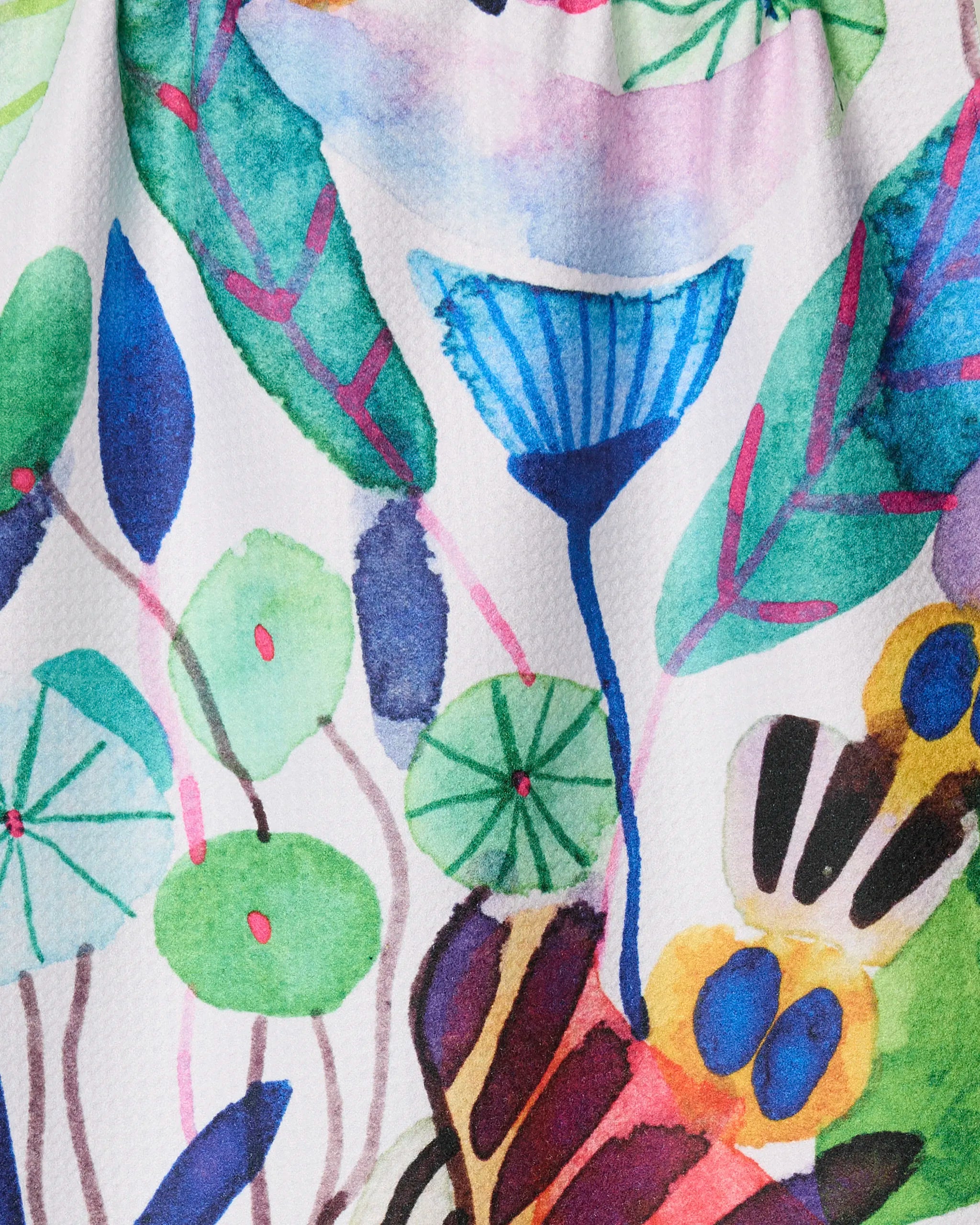 Morning" by Maria Montiel is a vibrant watercolor featuring abstract flowers and leaves in green, blue, pink, and yellow on a textured white background—perfect as an ultra-absorbent or recycled kitchen towel.