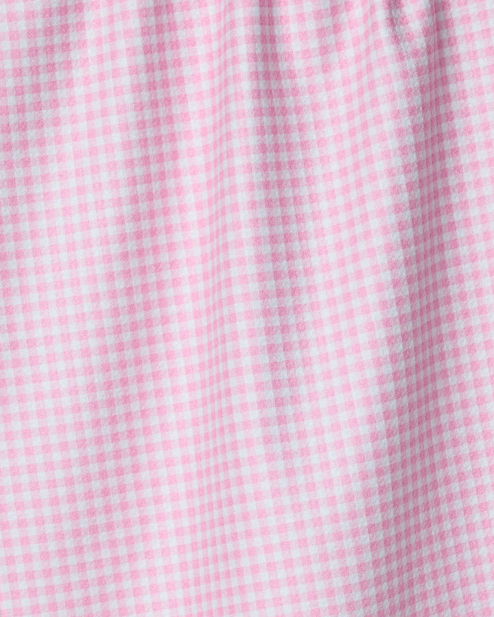 Close-up of the Geometry Most tea towel, its pink and white gingham pattern in quick-drying fabric creating gentle folds and soft shadows.