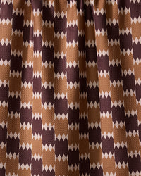 The Geometry Mountain Song recycled kitchen towel features a visually dynamic geometric pattern with alternating brown, tan, and beige diamond shapes in vertical rows.