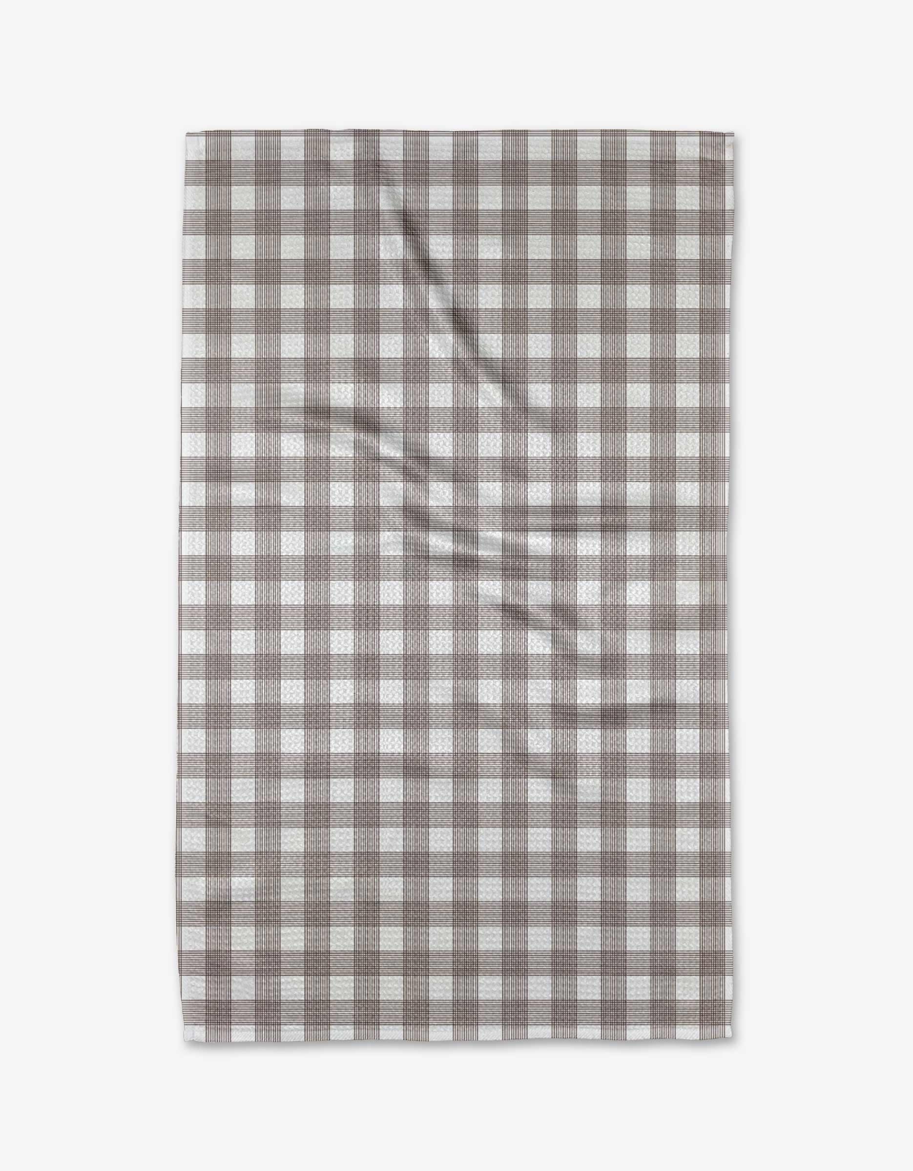 The Buy Guide’s Multi Gingham - Chocolate tea towel, made from Geoweave fabric in a brown and white checkered pattern, is shown laid flat with slight wrinkles visible.