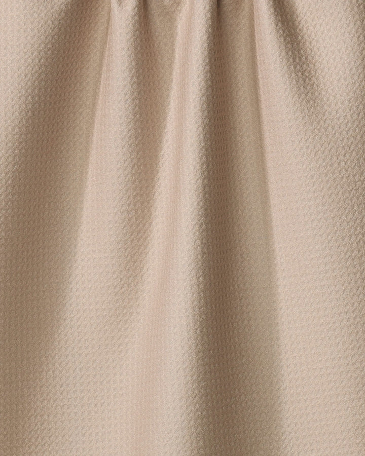 Close-up of “My Happy Place” by Kelsi Fullmer: an eco-friendly, light beige textured fabric with small geometric patterns and soft vertical folds—perfect for a stylish kitchen towel.