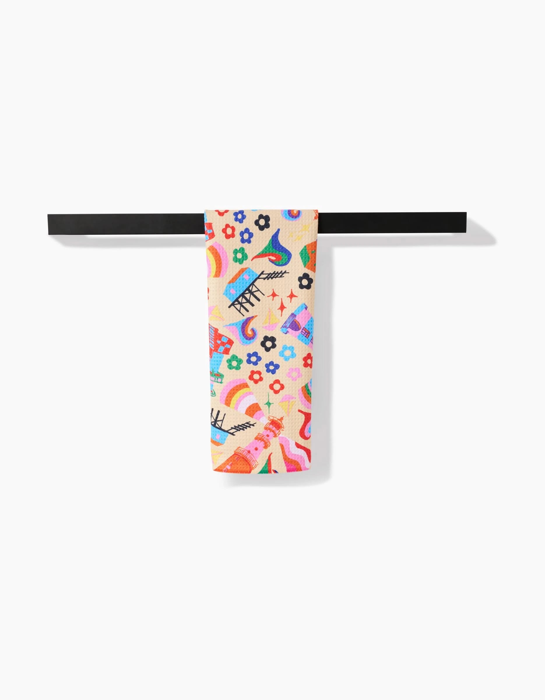 The My Place tea towel by Ania Zwara Art features playful abstract eyes, lips, flowers, and wavy shapes. Neatly folded over a black bar on a white background, its made from recycled materials for eco-friendly style.