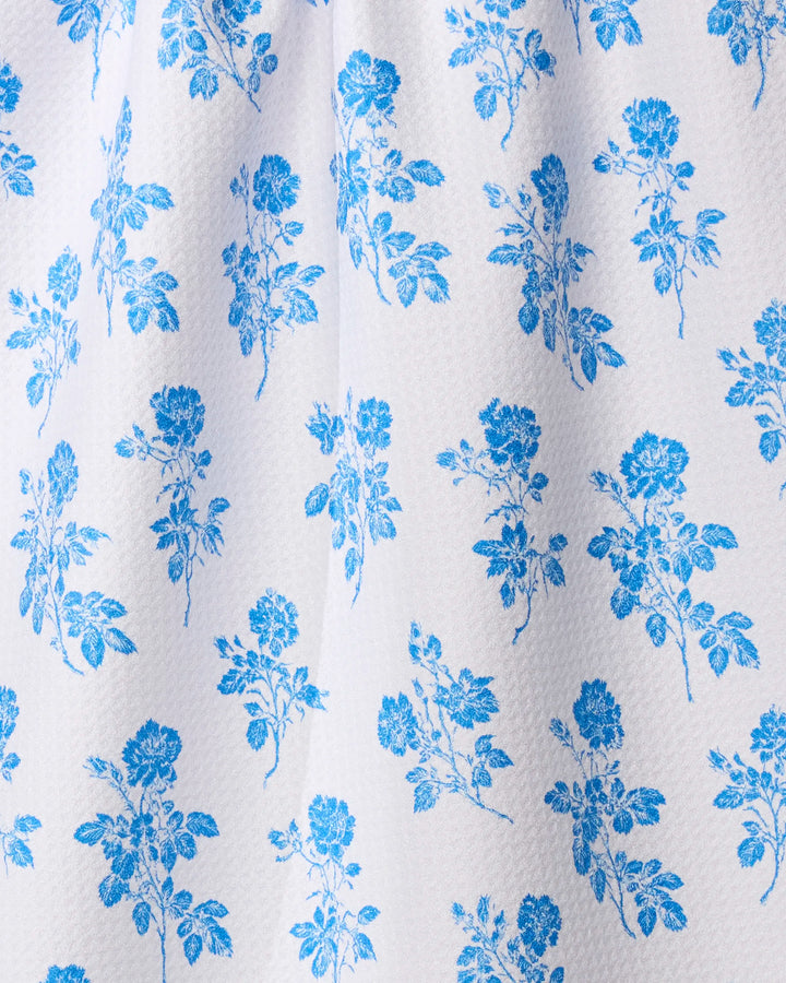 The Geometry Naxos tea towel features a white textured fabric with a blue floral rose pattern, made from recycled materials for ultra absorbency—perfect for your kitchen.