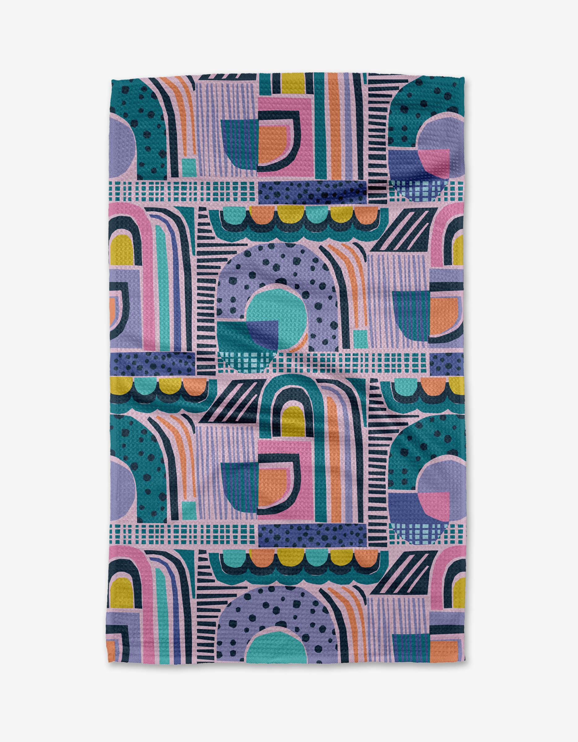 The New Dawn towel by Masha Volnova is a rectangular quick-drying towel with a bold, modern geometric pattern in purple, teal, blue, orange, pink, and yellow featuring arches, circles, dots, and lines.