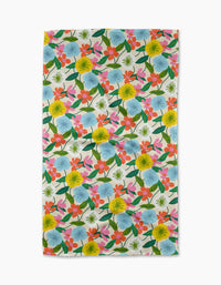 The New Mercies tea towel by Susan Heid features a colorful floral pattern with yellow, blue, orange, and pink flowers and green leaves on white, made from quick-drying recycled materials.