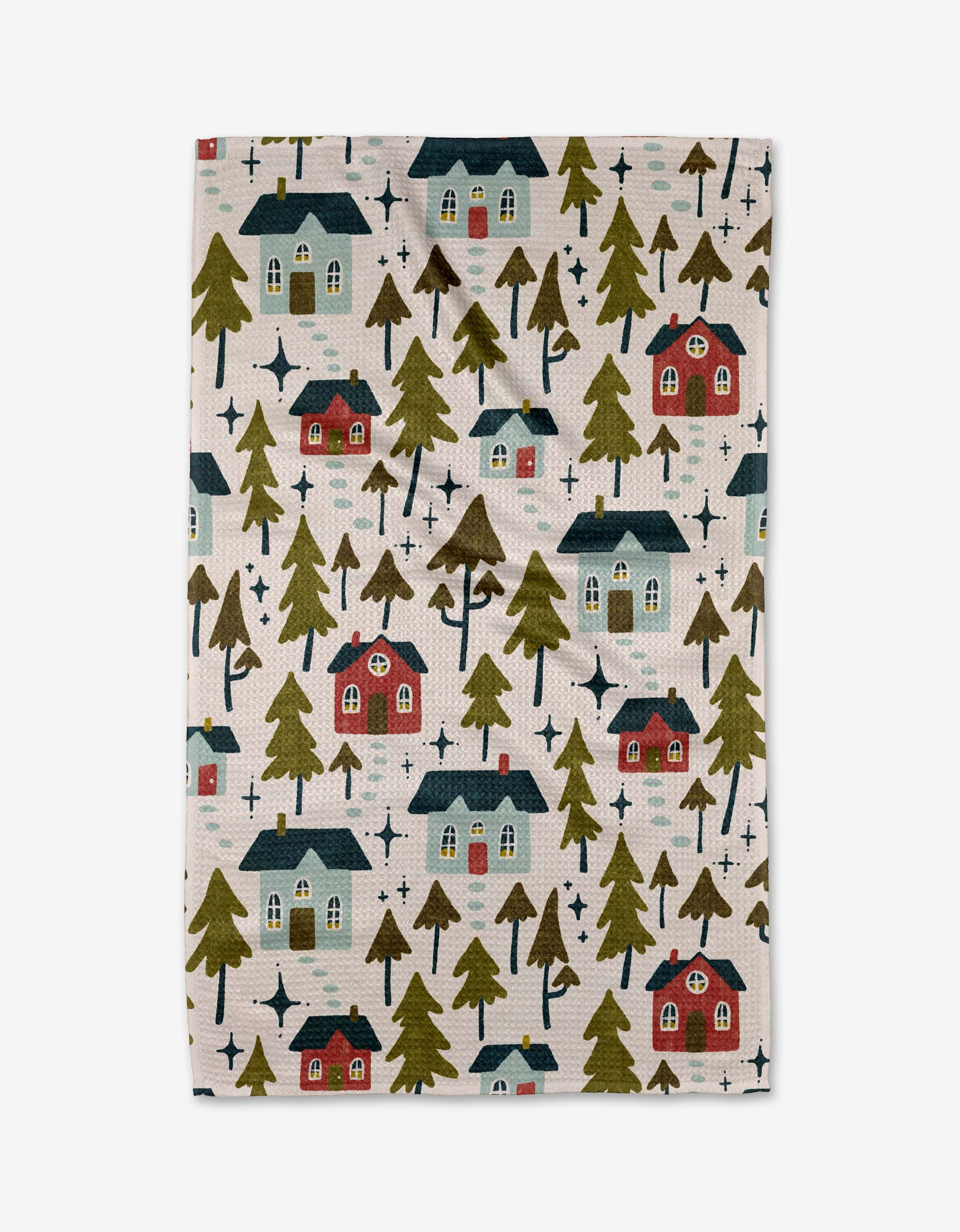 The Amy MacCready Nico Light is a quick-drying towel with a whimsical pattern of red and blue houses, green pine trees, and dark star shapes on a light background.