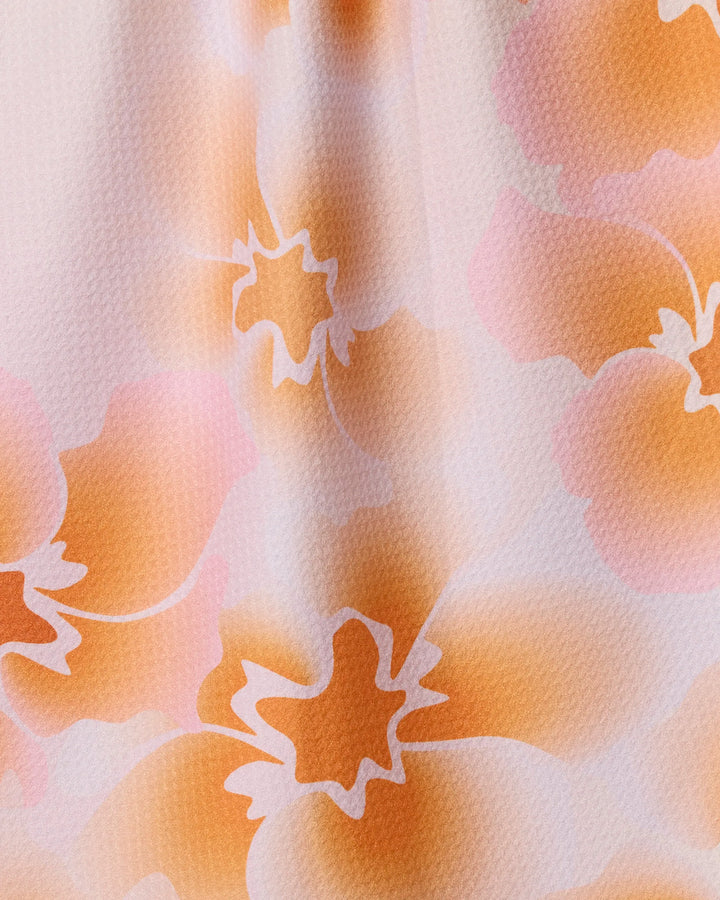 The Geometry Nicole tea towel features an abstract, close-up design of orange and pink florals on a light background, made from recycled materials with soft colors and white outlines—ultra-absorbent and perfect for your kitchen.