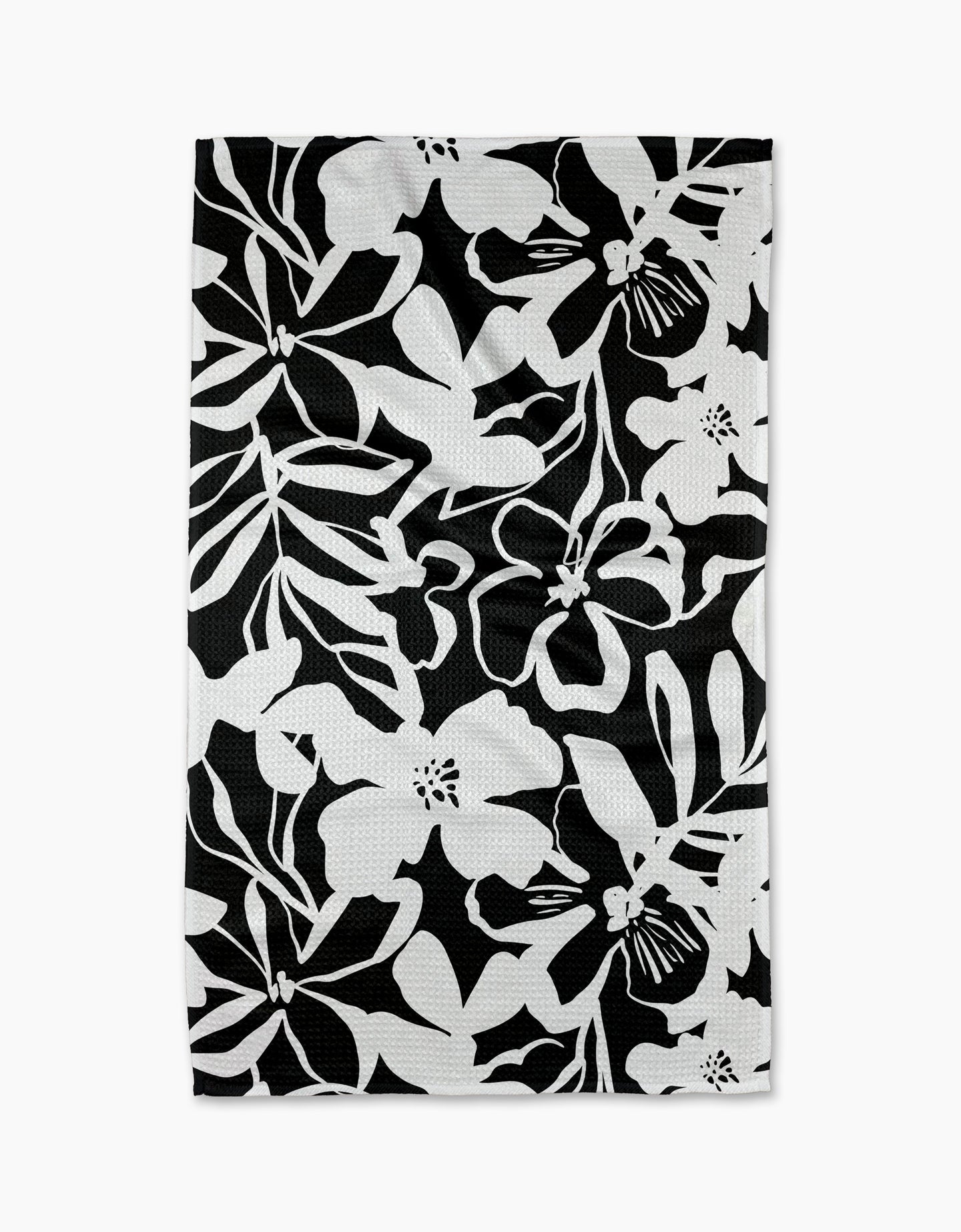The Night Meadow dish towel by Marina Solodka features a bold black and white floral pattern—ideal as an eco-friendly kitchen or tea towel.