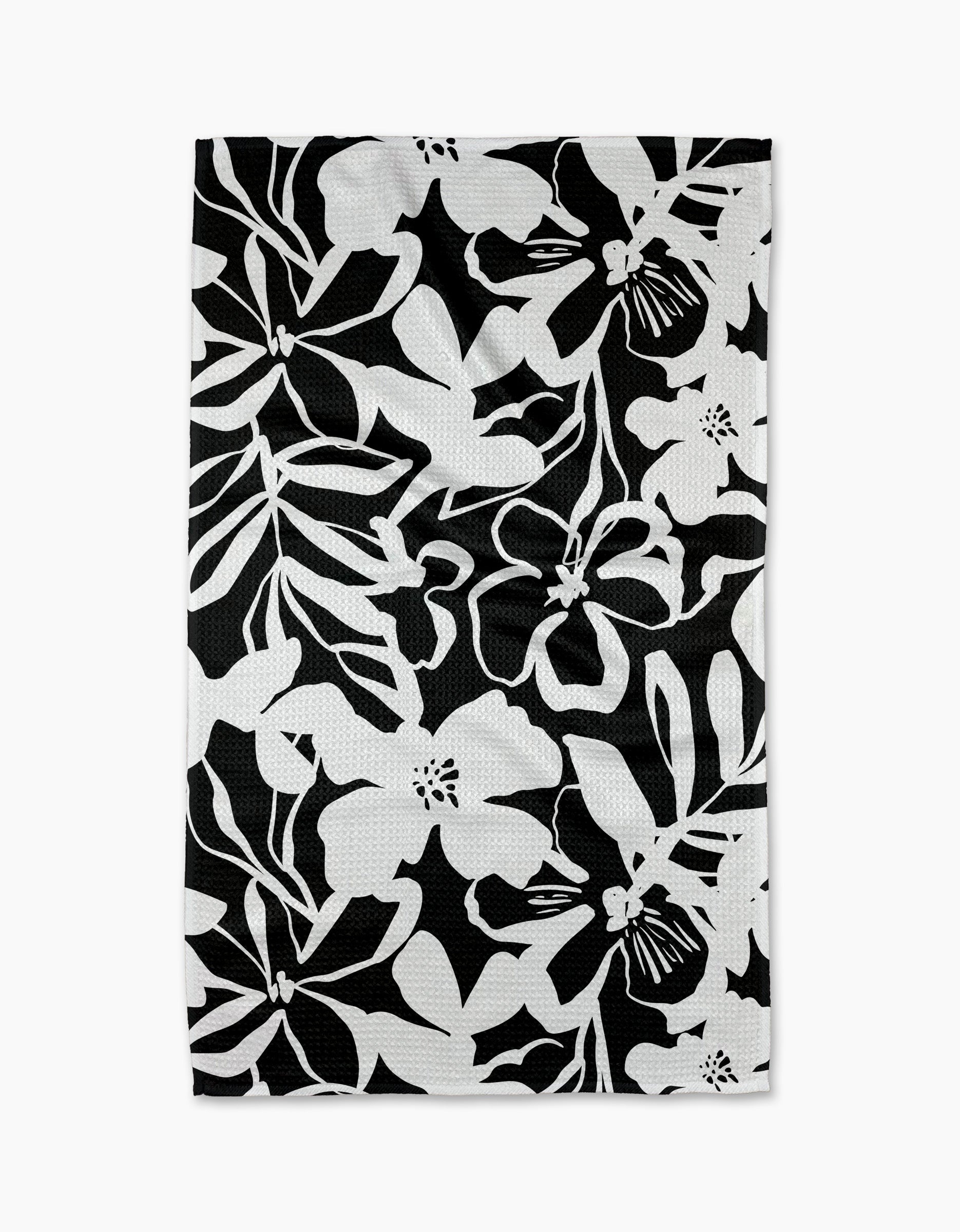 The Night Meadow dish towel by Marina Solodka features a bold black and white floral pattern—ideal as an eco-friendly kitchen or tea towel.