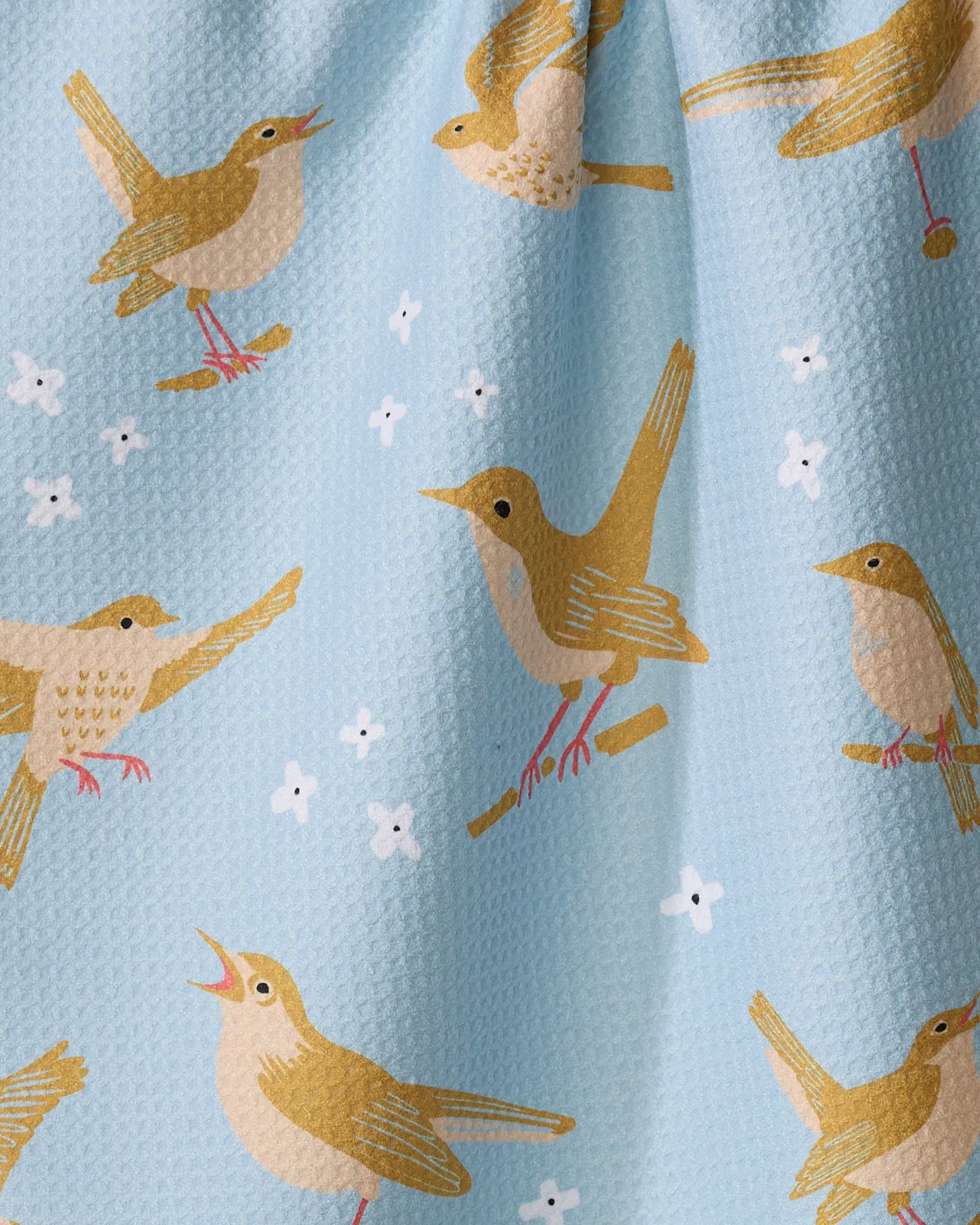 “Nightingales” by Elisabeth Wing features yellow and brown birds perched on branches, singing on a light blue textured background with white flower accents—perfect for an eco-friendly kitchen towel.