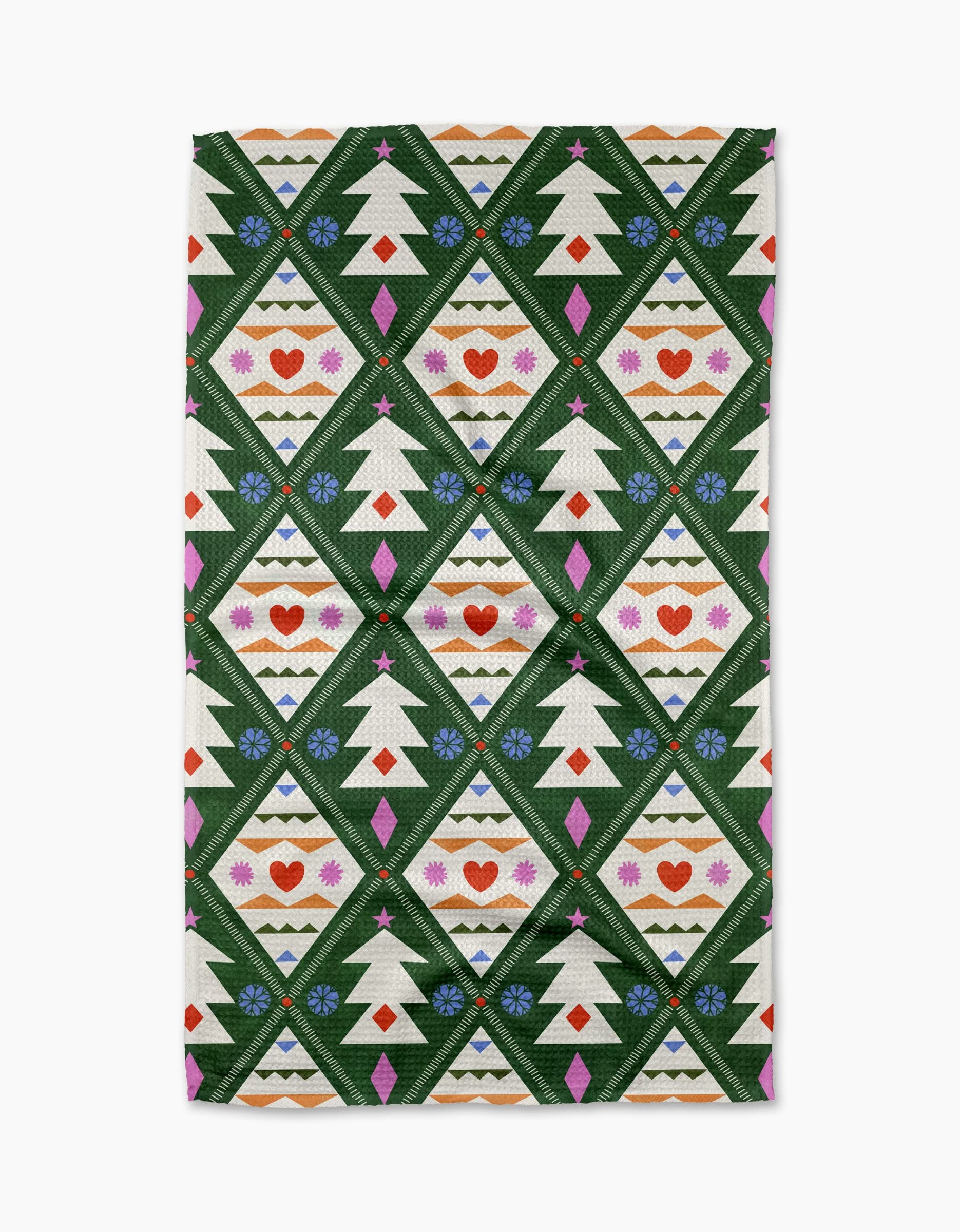 The Nordic Christmas tea towel by Claire Iglesias features white Christmas trees, red hearts, blue flowers, and pink diamonds in green outlines with decorative stripes on a white background.