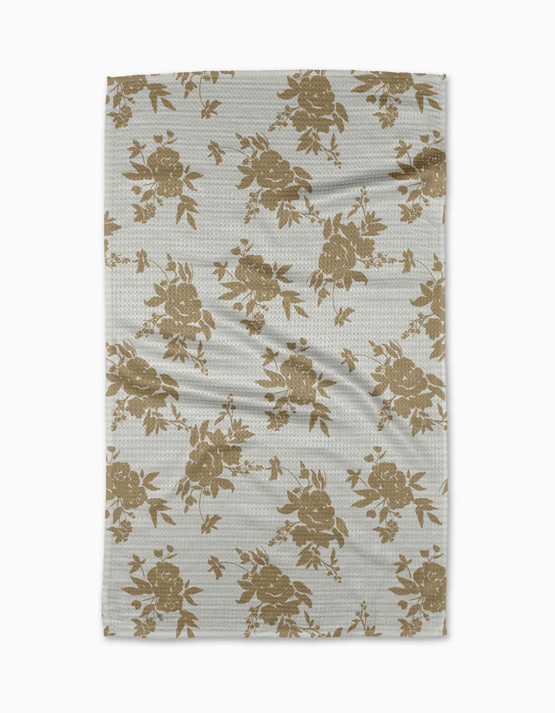 The Aubrey Fairchild Oatmeal Floral blanket is light gray, made from recycled materials, and features a repeating beige floral pattern with leaves and flowers evenly spread across the surface.