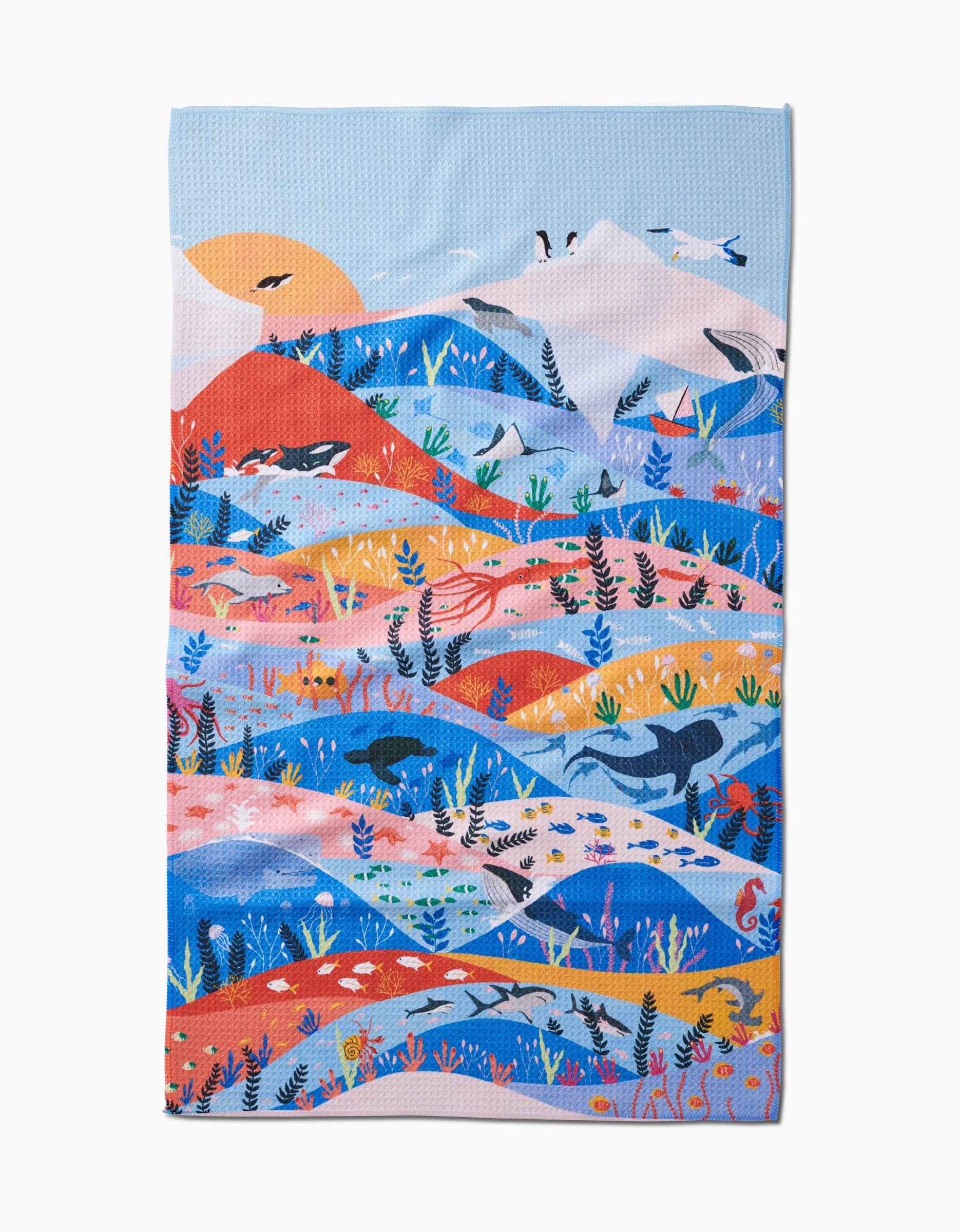 Oceans by Ceyda Alasar: a tea towel featuring a vibrant landscape of mountains, hills, plants, birds, and whales in blue, orange, and red beneath the sun—crafted with absorbent Geoweave™ fabric.