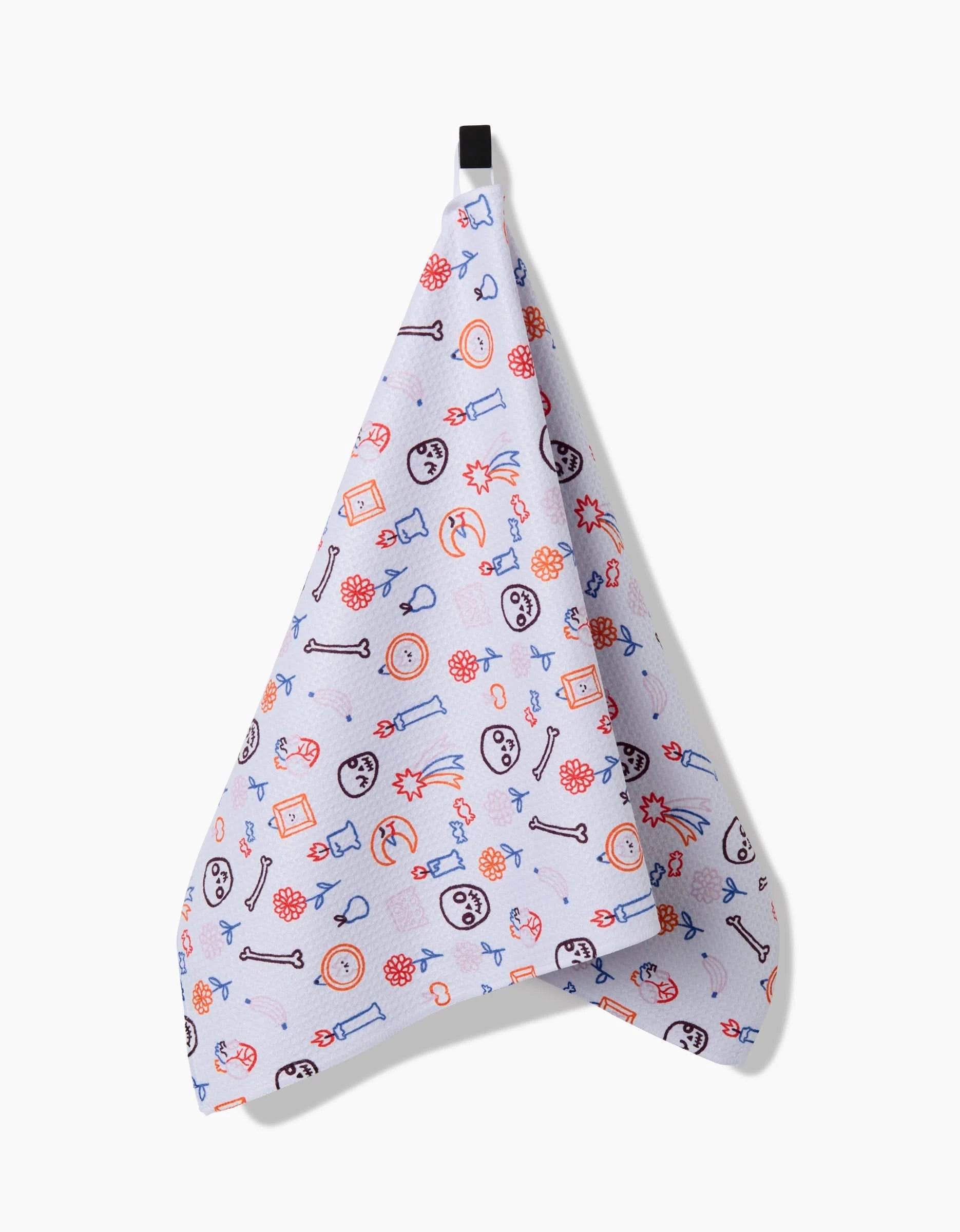 The So Lazo Offerings tea towel is white, made from recycled materials, and displays playful, colorful dog-themed illustrations—bones, paw prints, faces, and toys—hanging from a black loop.