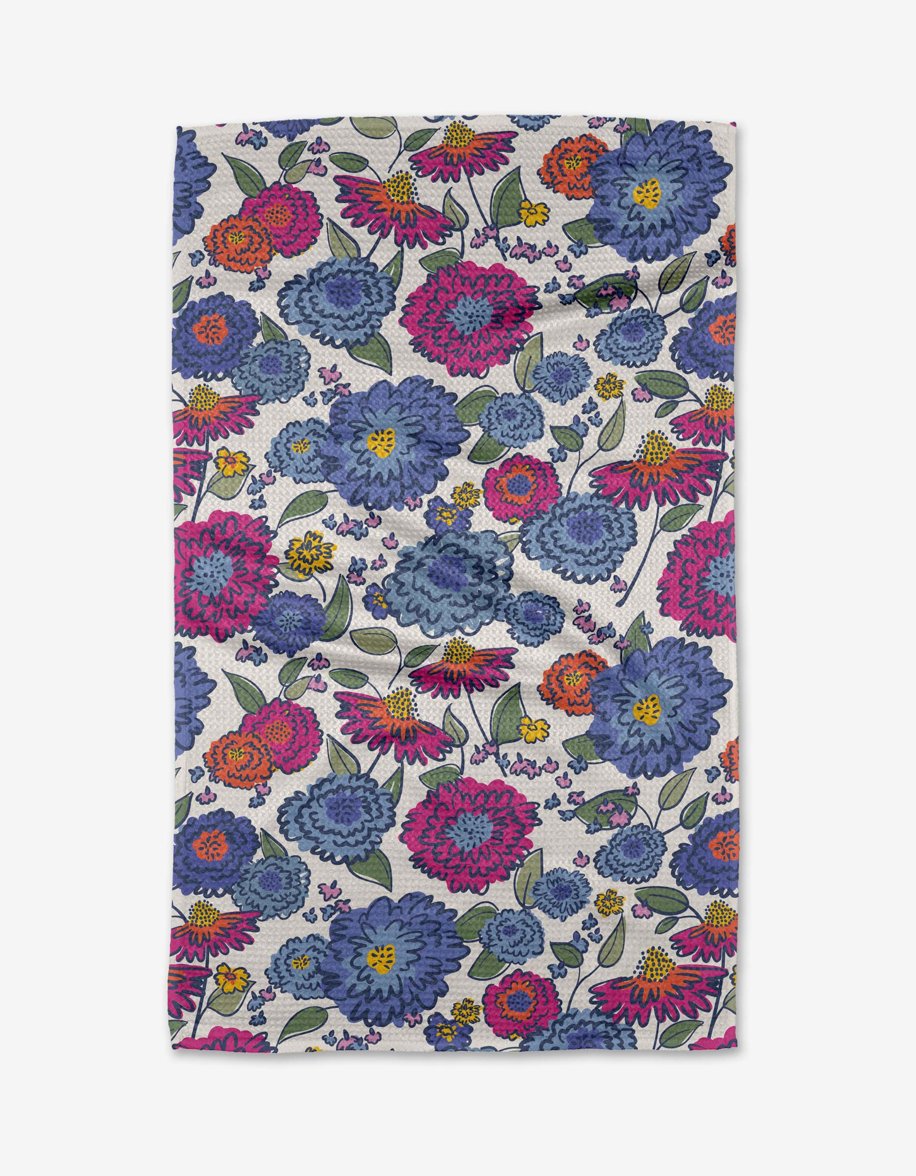 The Kris Ruff Painterly Meadow towel is a rectangular, ultra-absorbent white towel with a colorful floral pattern of large blue, pink, yellow, and purple flowers plus green leaves scattered across the surface.