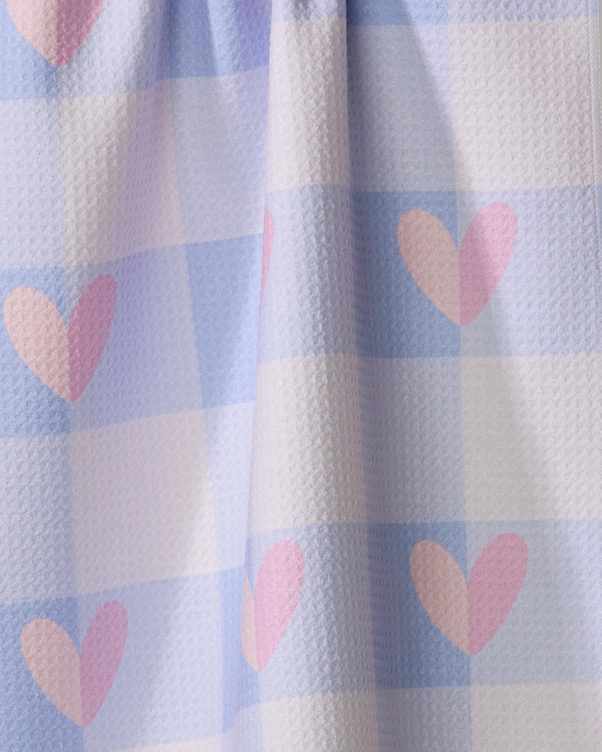 Pastel Picnic Hearts by Letters By Shells is an ultra-absorbent kitchen towel with a light blue and white checkered pattern, scattered pink hearts, and a textured finish—perfect for use as a tea or kitchen towel.