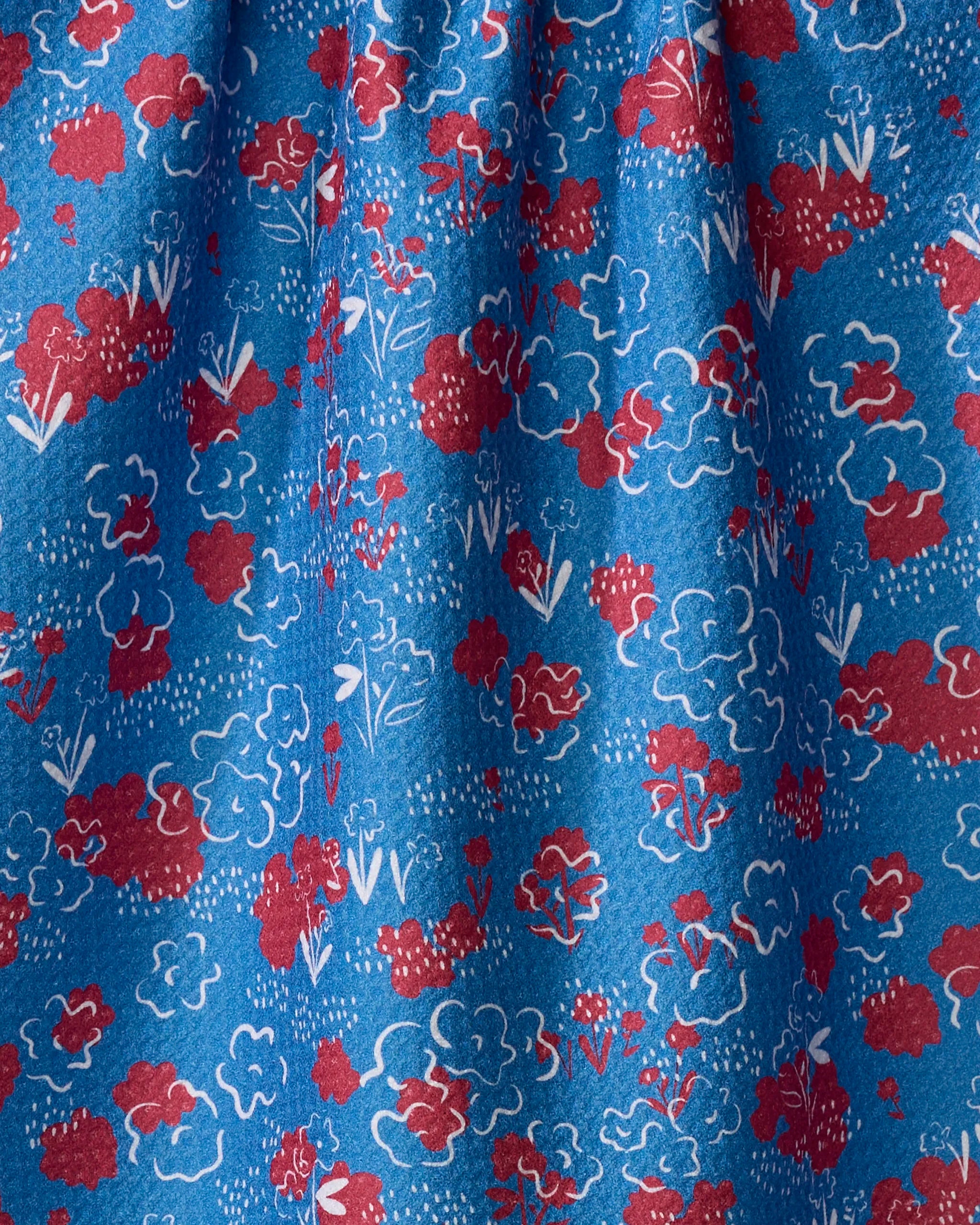 The Second Nature Studio "Patriotic Garden" towel features a soft blue fabric with red and white floral clusters, gentle folds, scattered dots, and an ultra-absorbent, textured finish.