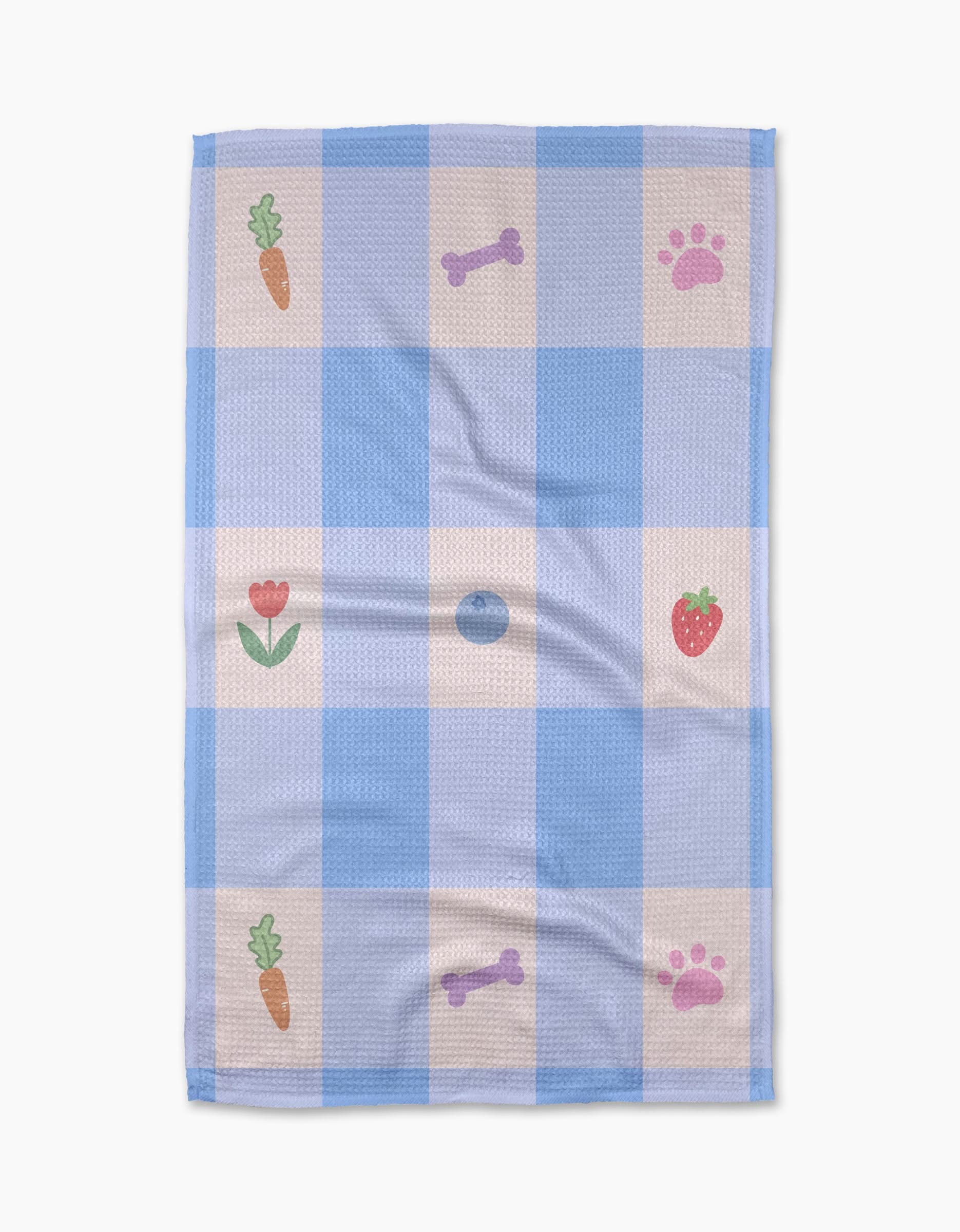 The Pawfect Picnic towel by Letters By Shells is a blue and white checkered, ultra-absorbent towel with carrot, strawberry, bone, paw print, and tulip patterns in some squares.