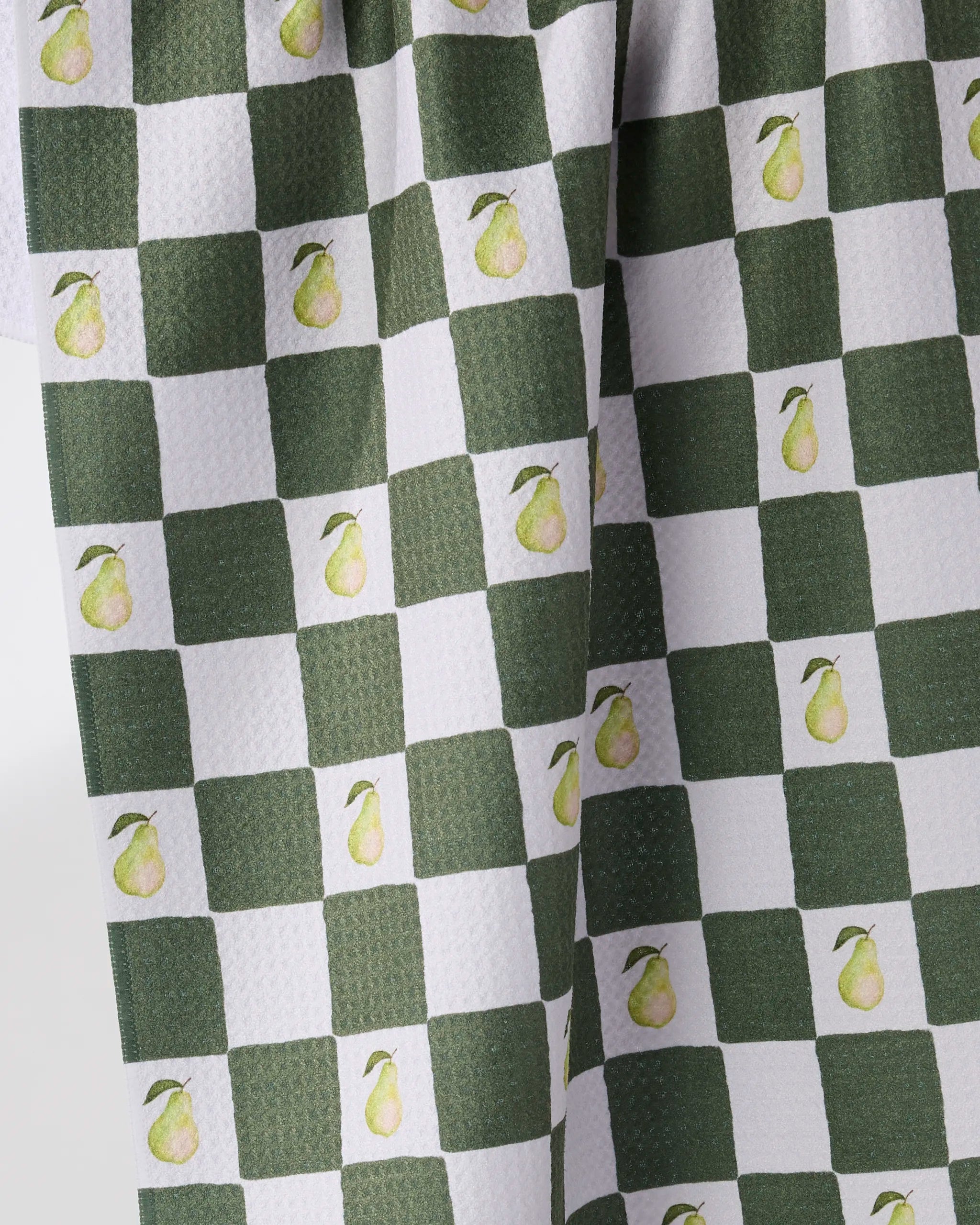 The Geometry Pear Checker kitchen tea towel features a green and white checkerboard pattern with pears in each green square, plus an ultra-absorbent, textured surface.