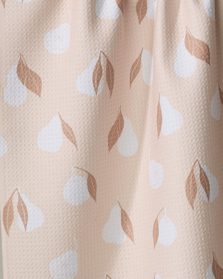 A close-up of the Pears Kitchen Tea Towel by Hufton Studio, featuring light pink Geoweave fabric with white pear shapes and brown leaves for a soft, subtle fruit-themed design.