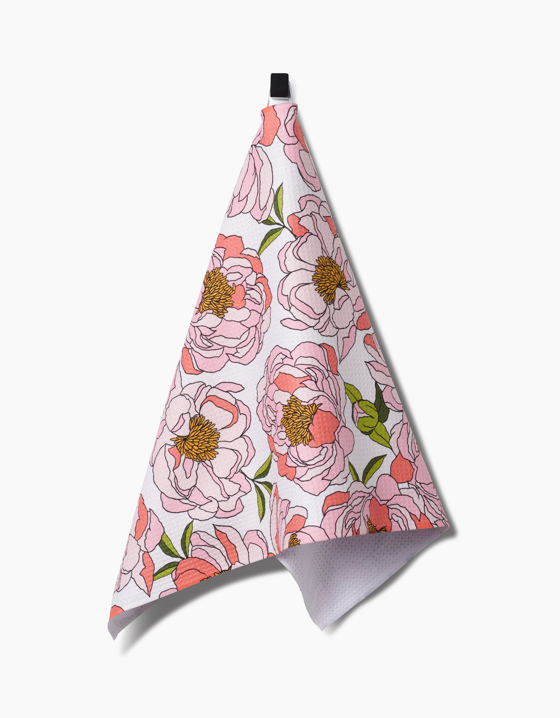 The Peony Paradise towel, crafted from ultra-absorbent Geoweave fabric and featuring a pink and green floral design, hangs from a black loop against a plain white background.