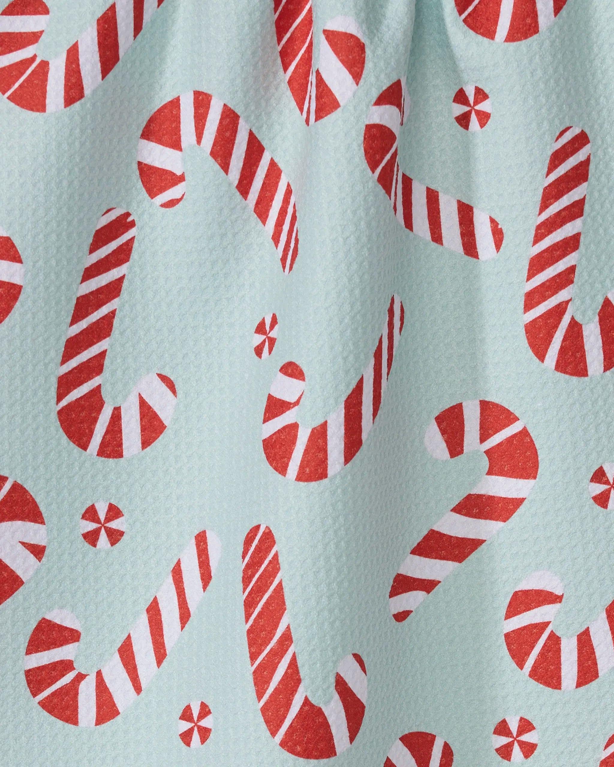 Peppermint Twist by Geometry features red and white striped candy canes and peppermint candies on a light blue textured background—ideal for adding festive flair to your tea towels or ultra-absorbent towel designs.