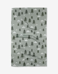 The Pine Forest Tea Towel by Coit Creative is a green, rectangular towel made from Geoweave™ fabric, featuring dark green pine trees and white clouds patterned across the surface.