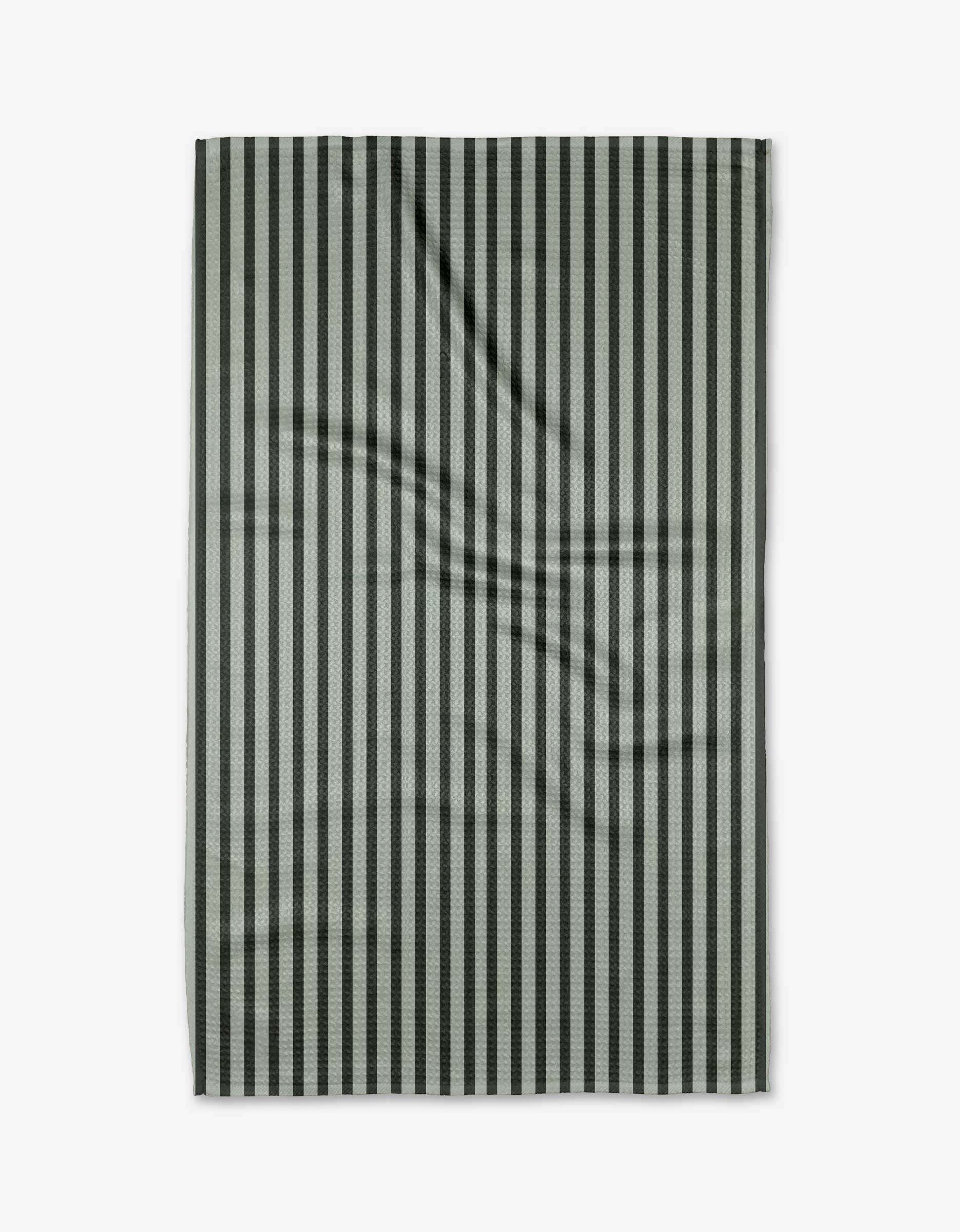 The Pine Stripe tea towel by Kelsi Fullmer features vertical black and gray stripes. Made from recycled materials, this ultra-absorbent, stylish, and sustainable textile is shown flat on a white background with visible folds.