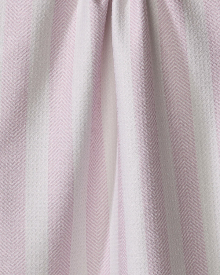 Close-up of the Teri the Butter Pink Chevron Stripe kitchen tea towel, showcasing pale pink and white vertical stripes with a subtle herringbone texture and soft folds.