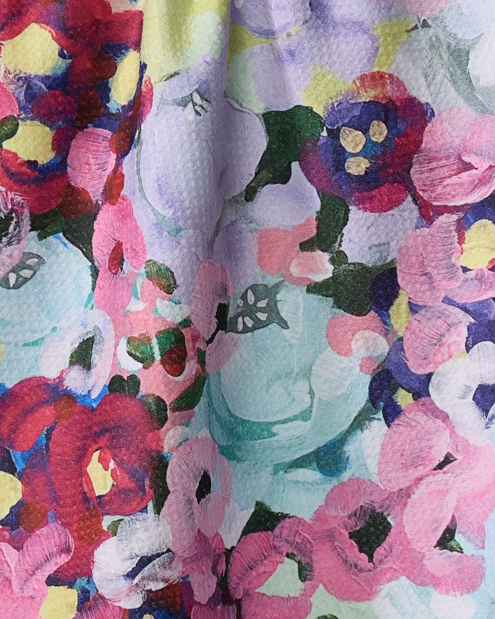 Pink Fields of Joy" by Ania Zwara Art features a vibrant abstract floral pattern with red, pink, purple, and yellow brushstrokes on a textured recycled kitchen towel background for a colorful, artistic look.