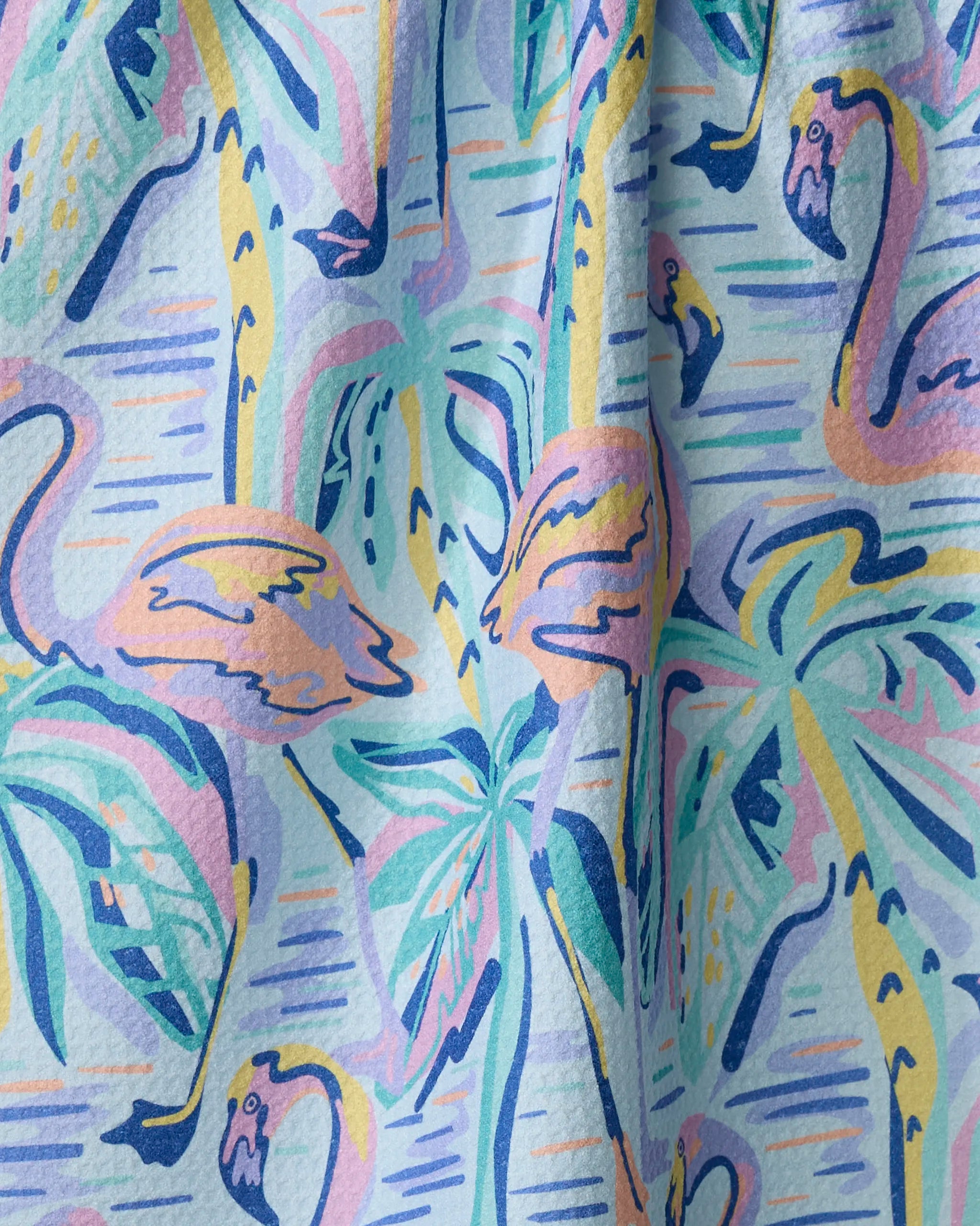 The Pink Flamingo recycled kitchen towel by Masha Volnova features a lively tropical watercolor pattern with pastel flamingos and palm leaves, plus a slightly wrinkled texture for added character.