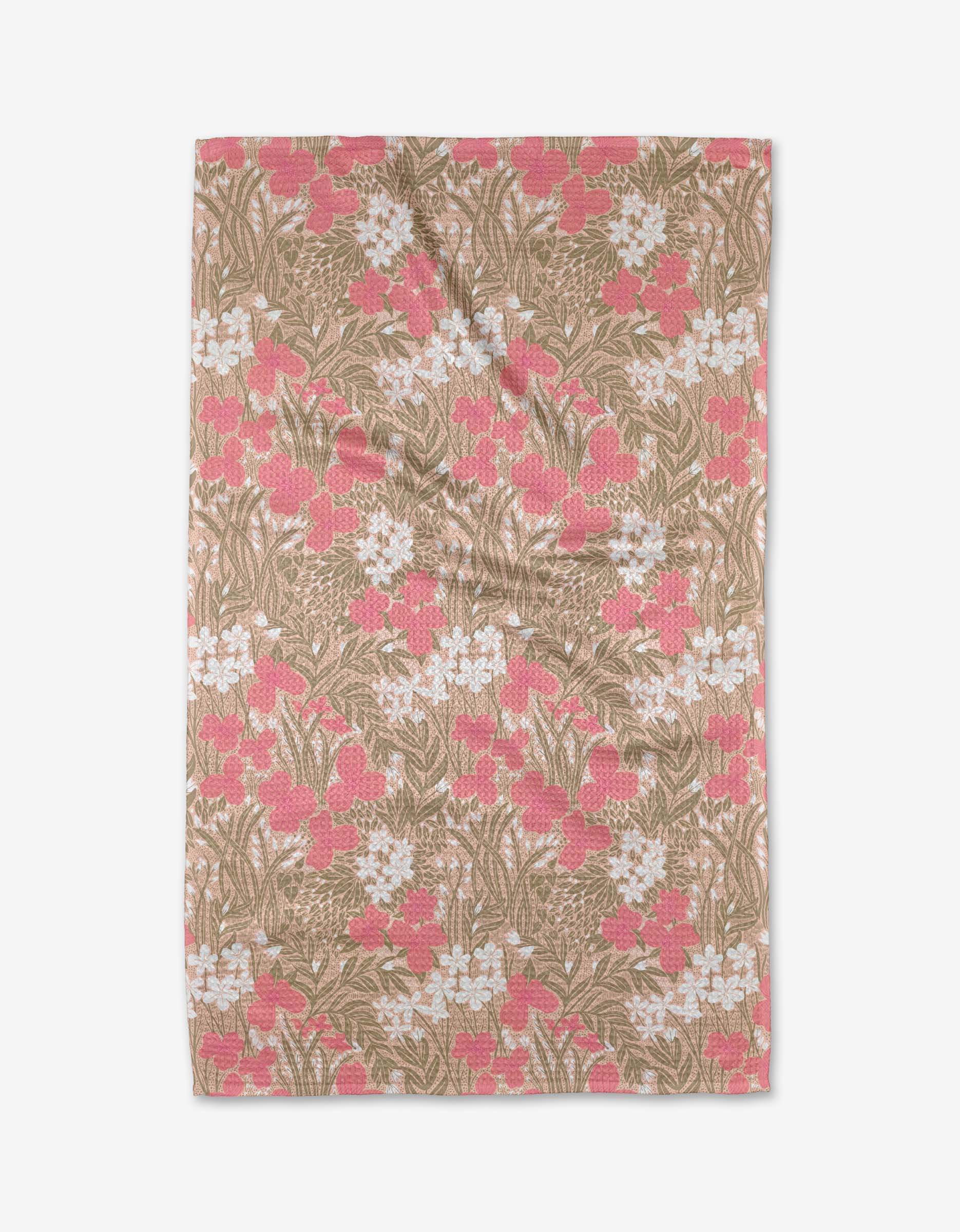The Katie OShea Pink Meadow tea towel is rectangular, made from recycled materials, and features a floral pattern of white and pink flowers with green leaves on a light brown background.