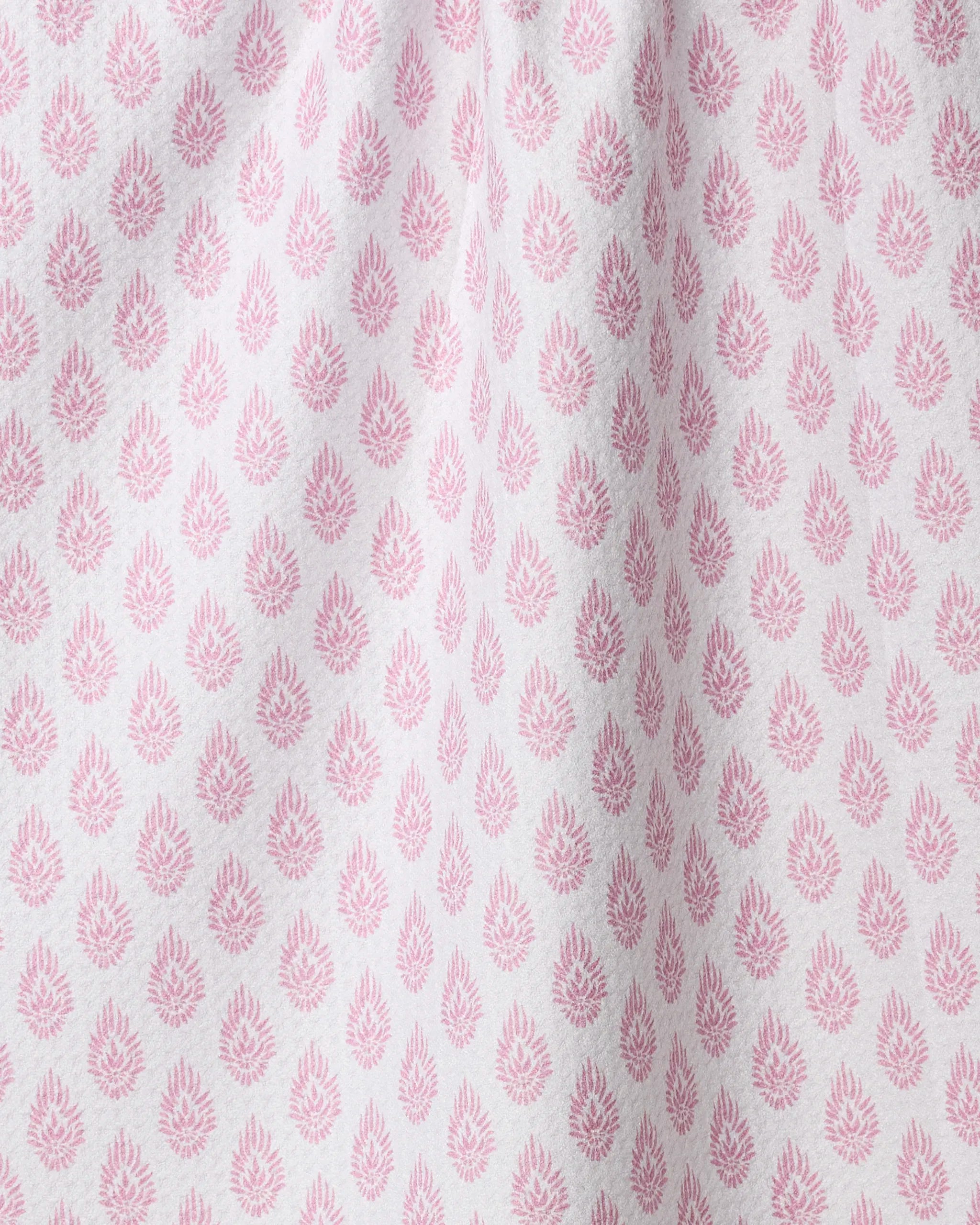 The Geometry Pink Poppy tea towel features ultra-absorbent white fabric with a soft texture and a repeated pink floral pattern, evenly spaced in rows for a stylish and functional kitchen accessory.